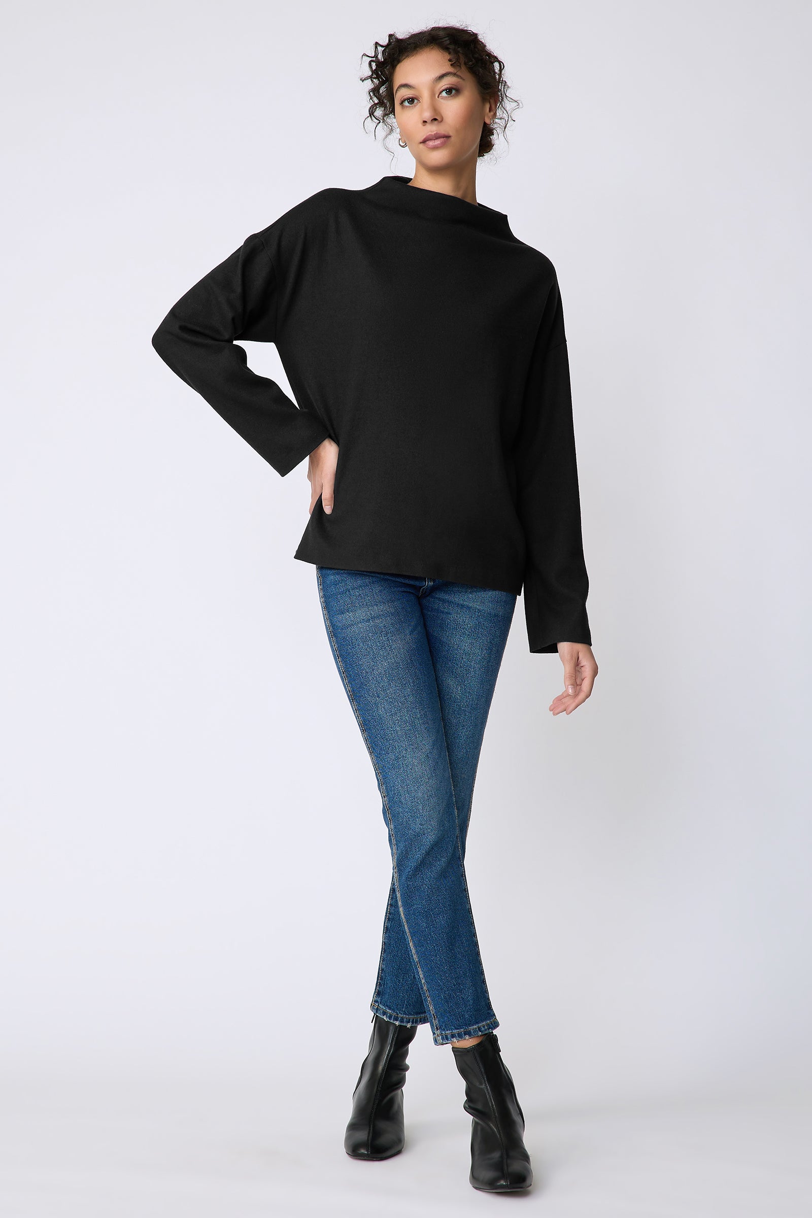 Kal Rieman Ethel mock funnelneck in black felted jersey on model front view hand on hip