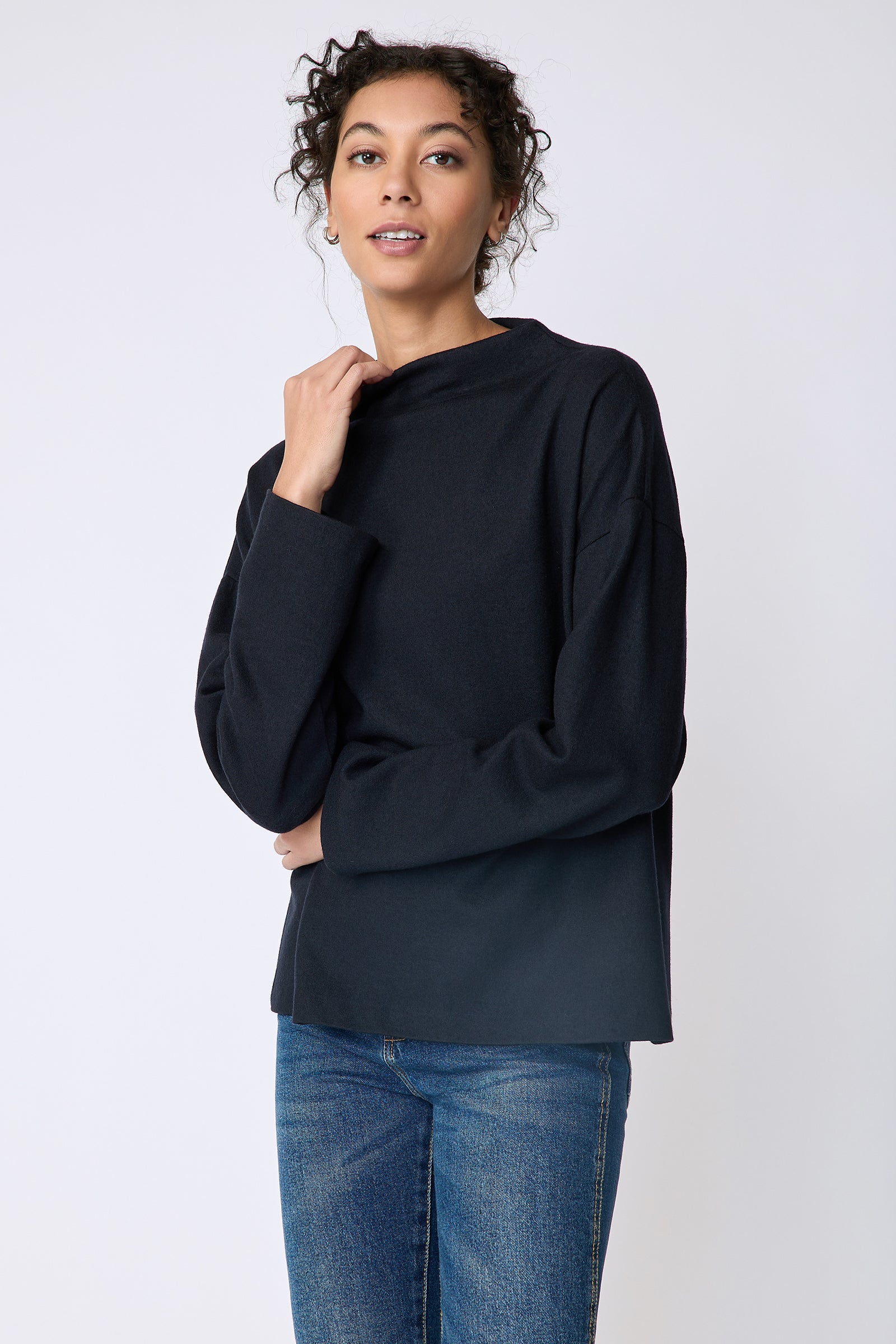 Kal Rieman Ethel mock funnelneck in midnight felted jersey on model front view detail holding collar