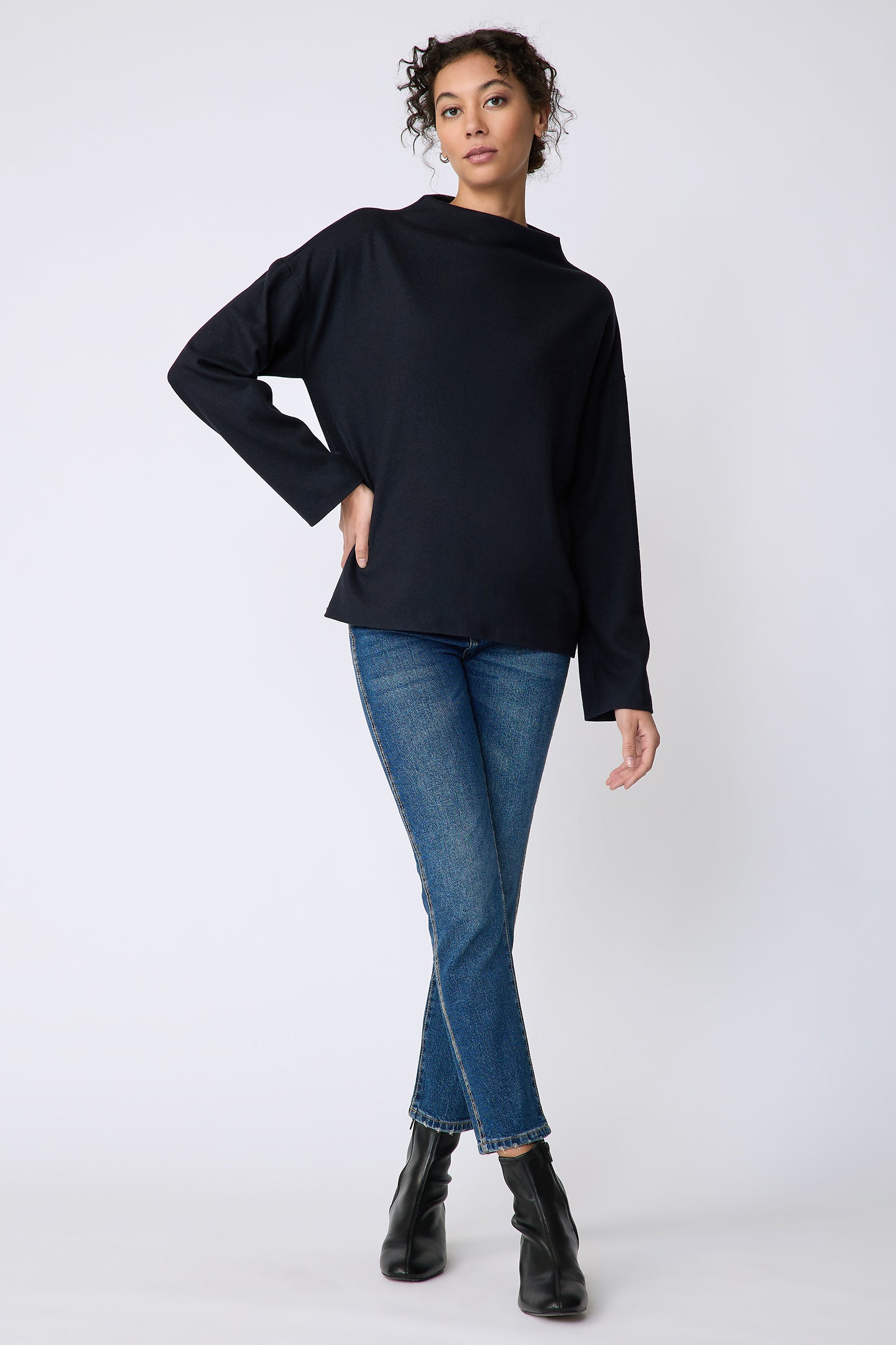 Kal Rieman Ethel mock funnelneck in midnight felted jersey on model front view hand on hip