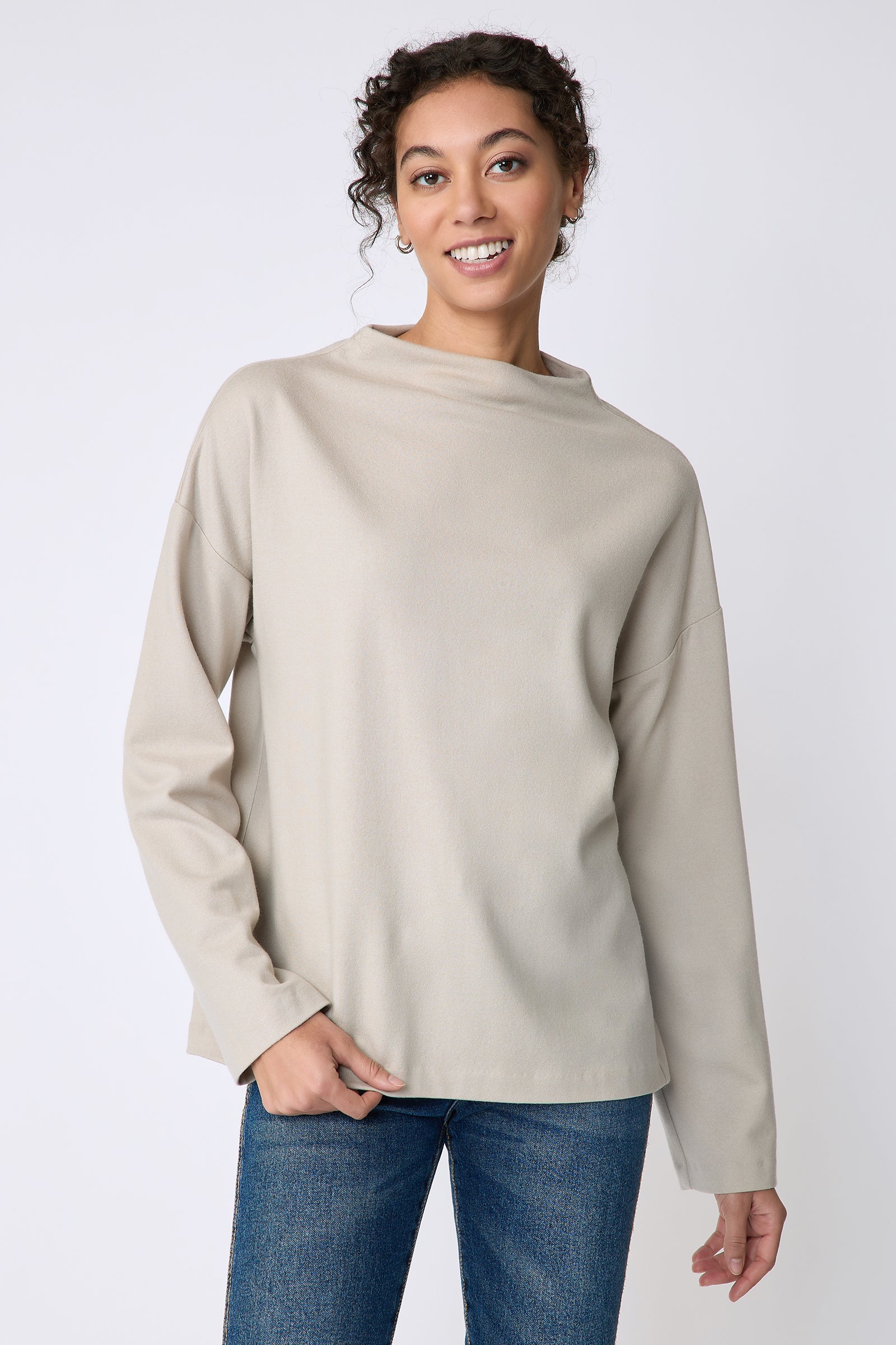 Kal Rieman Ethel mock funnelneck in mink felted jersey on model front view holding hem