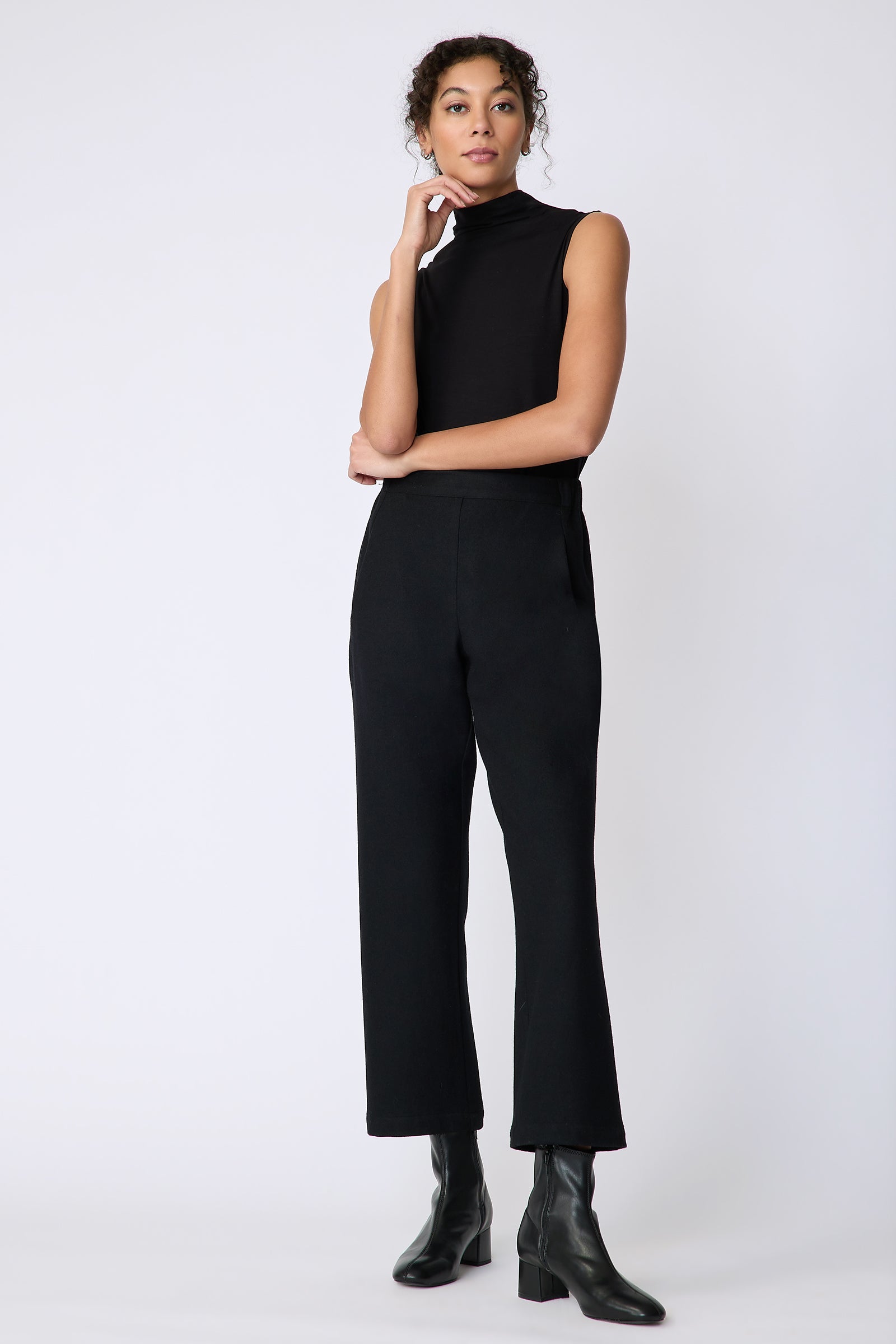 Kal Rieman Felted Jersey Angle seam crop pant in black on model front view hand on face