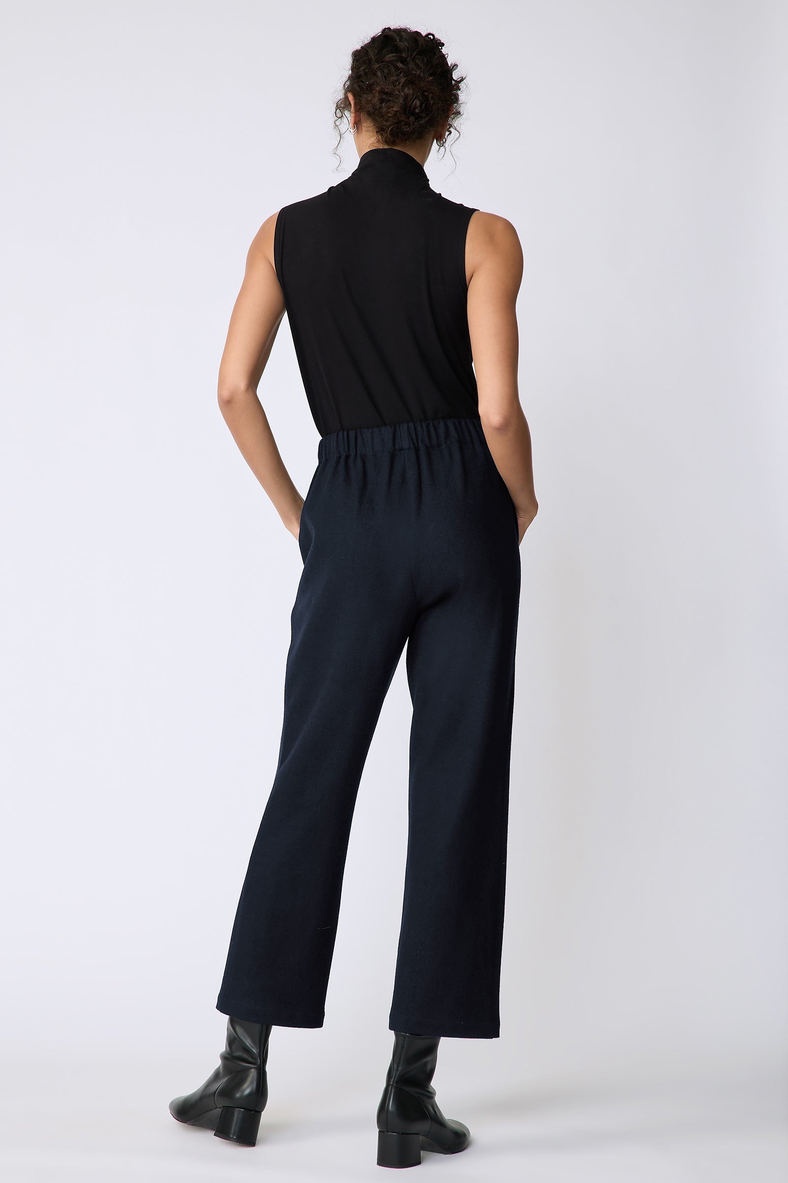 Kal Rieman Felted Jersey Angle seam crop pant in midnight on model front view hand on face