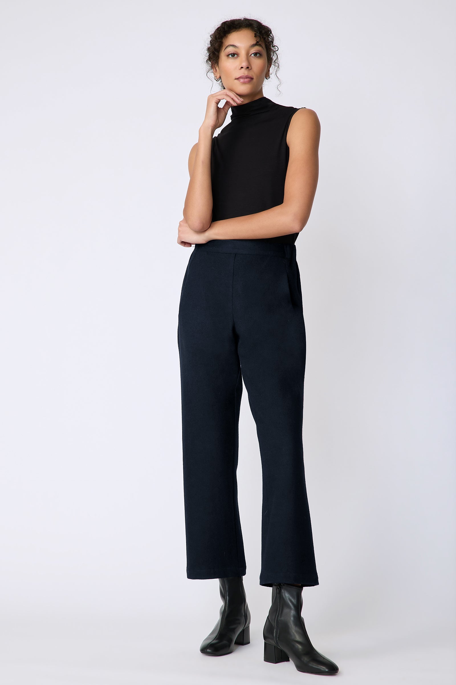 Kal Rieman Felted Jersey Angle seam crop pant in midnight on model front view hand on face