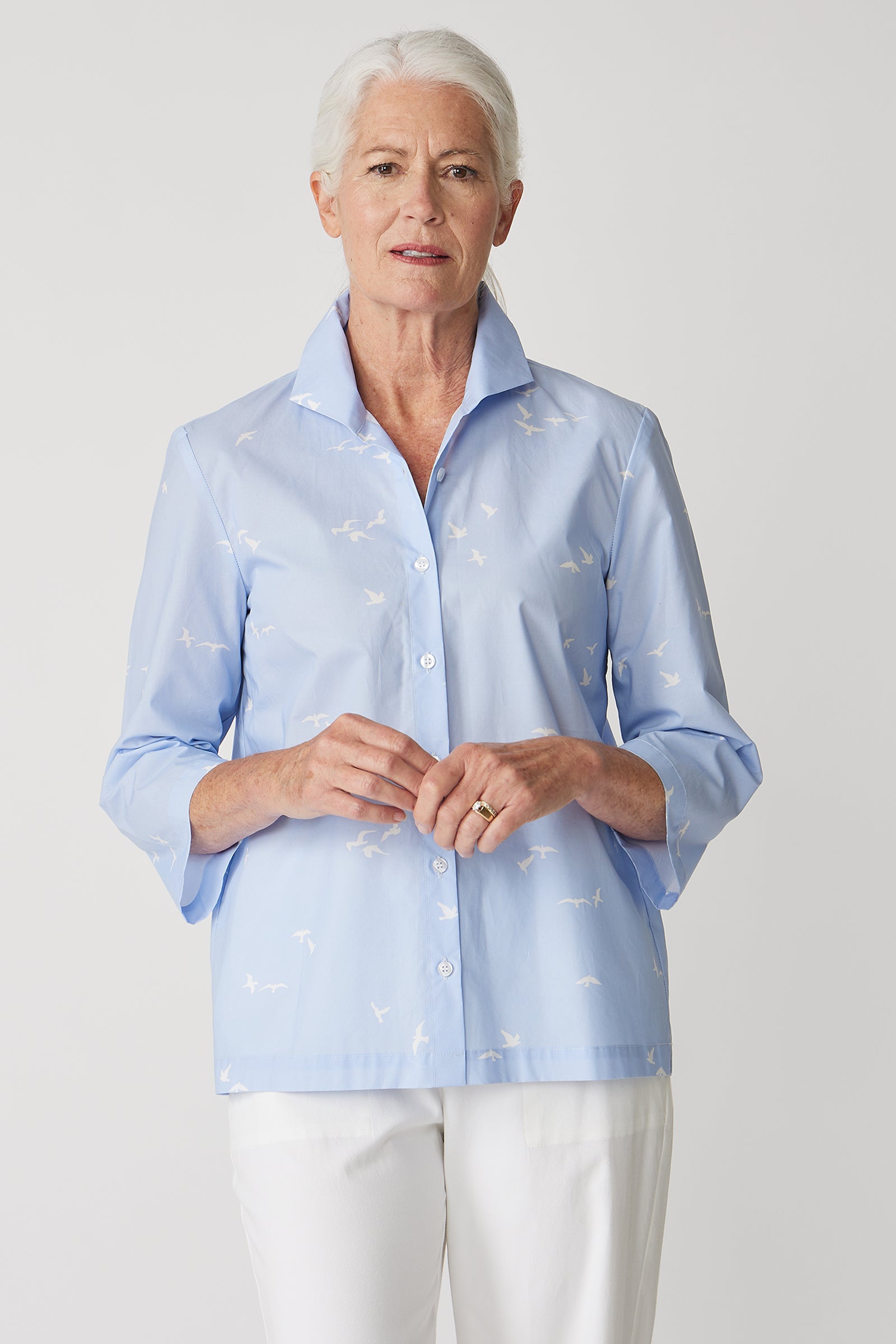 Kal Rieman 3/4 Sleeve Ginna Shirt in Oxford Blue Bird Print on model with hands in front