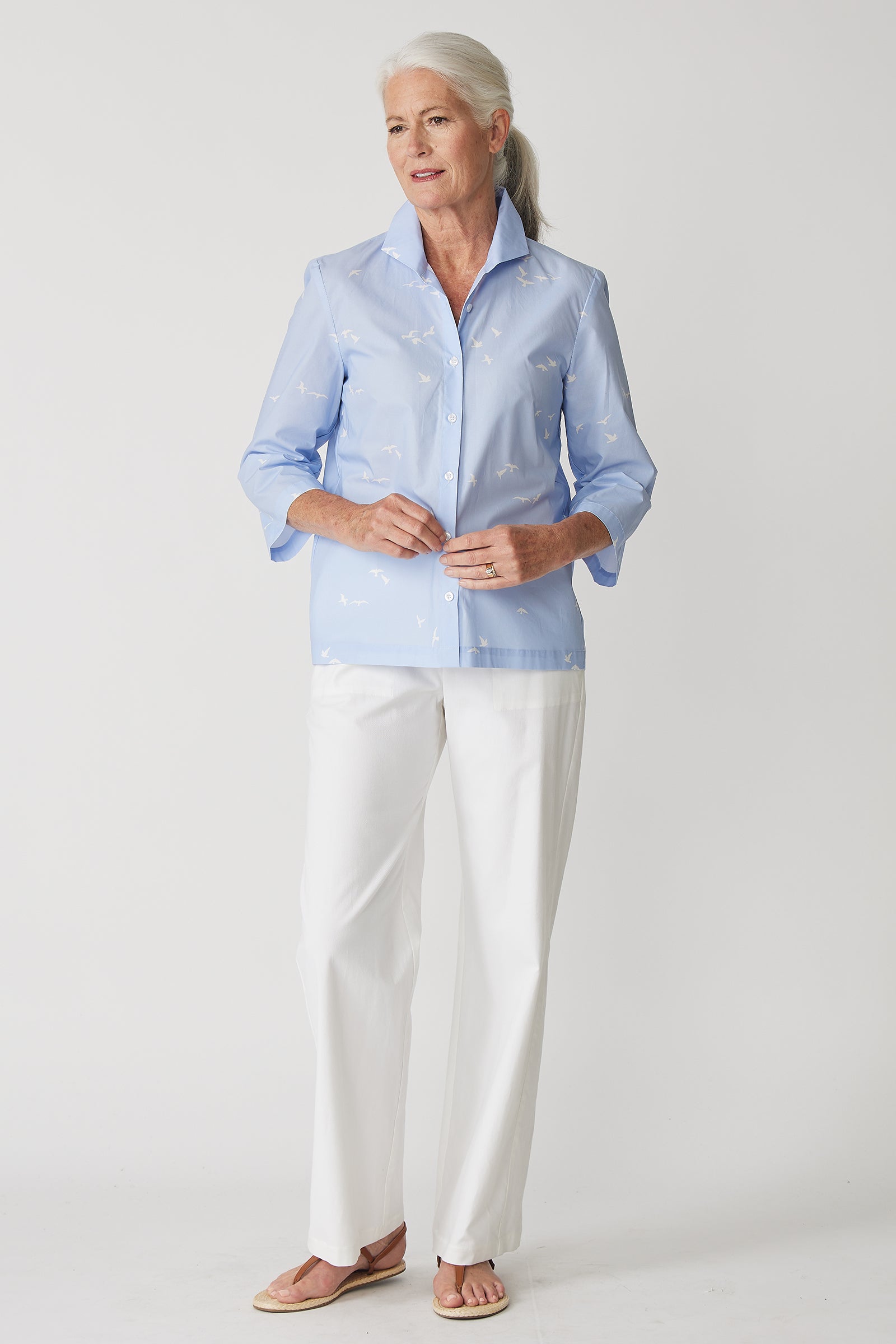 Kal Rieman 3/4 Sleeve Ginna Shirt in Oxford Blue Bird Print on model with hands touching front of shirt