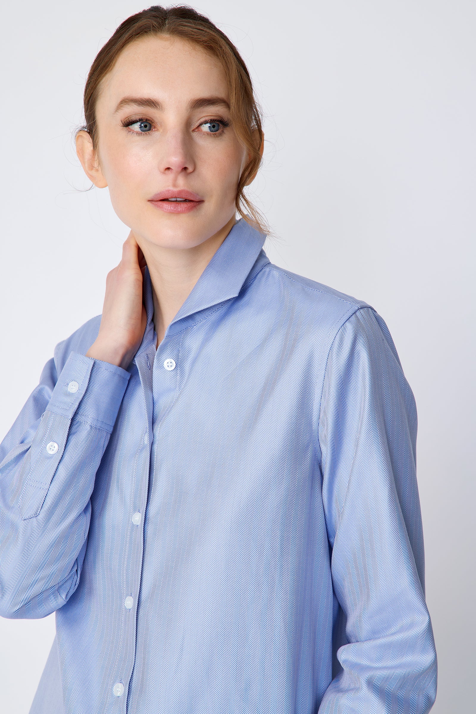 Kal Rieman Ginna Box Pleat Shirt in blue french blue herringbone on model front view holding neck
