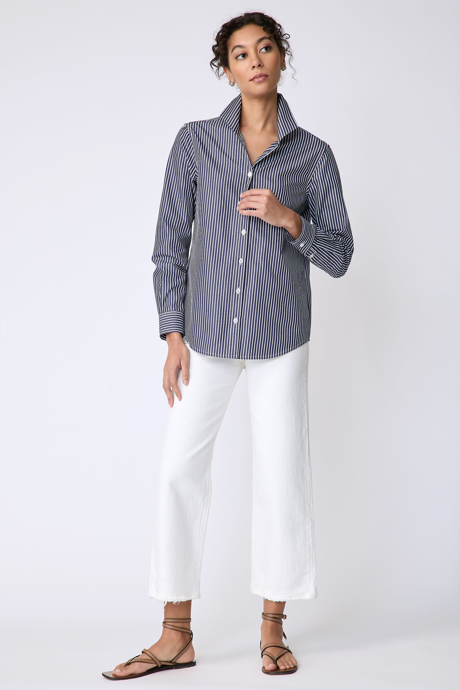 Kal Rieman Ginna Box Pleat Tailored Shirt in Savoy Stripe on model front view holding front of shirt