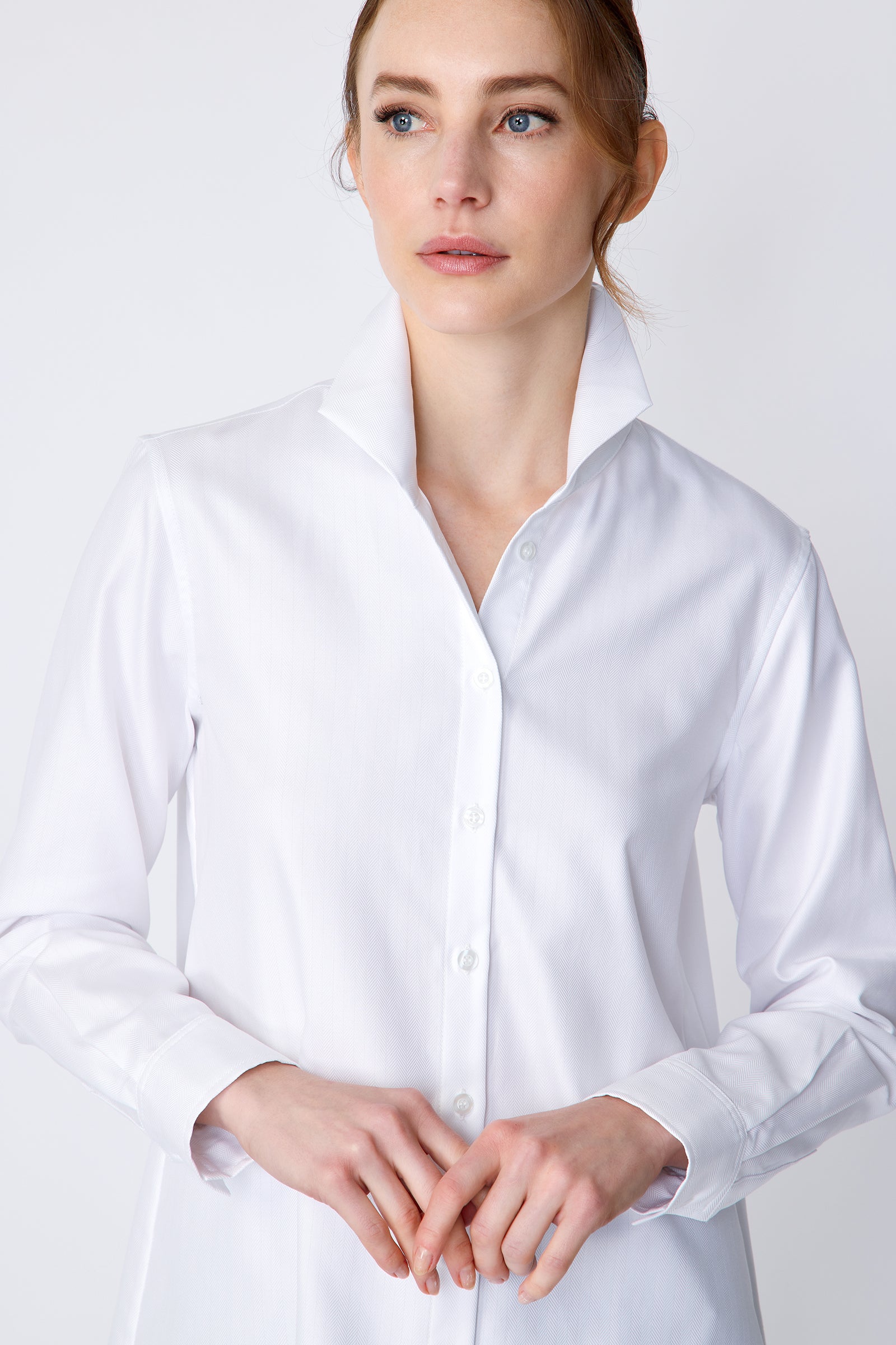 Kal Rieman Ginna Box Pleat Tailored Shirt in white fine herringbone on model front view detail hands in front