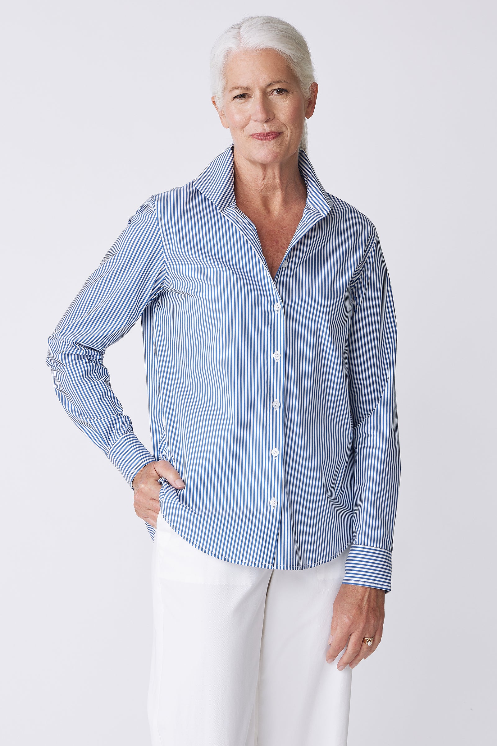 Kal Rieman image of the Ginna Box Pleat Shirt in Miami Stripe Blue on model with hand on hip front view