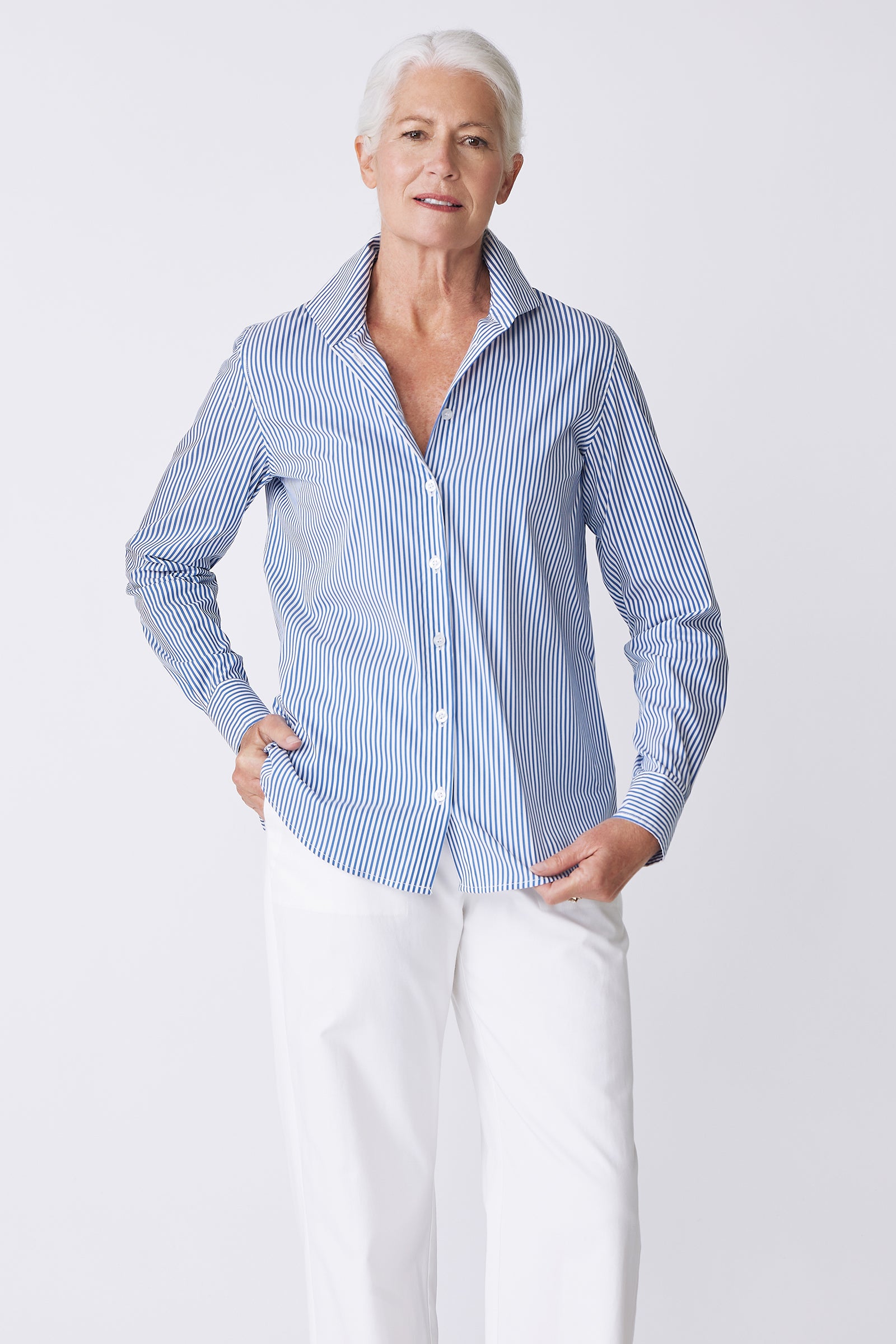 Kal Rieman image of the Ginna Box Pleat Shirt in Miami Stripe Blue on model holding front of shirt front view