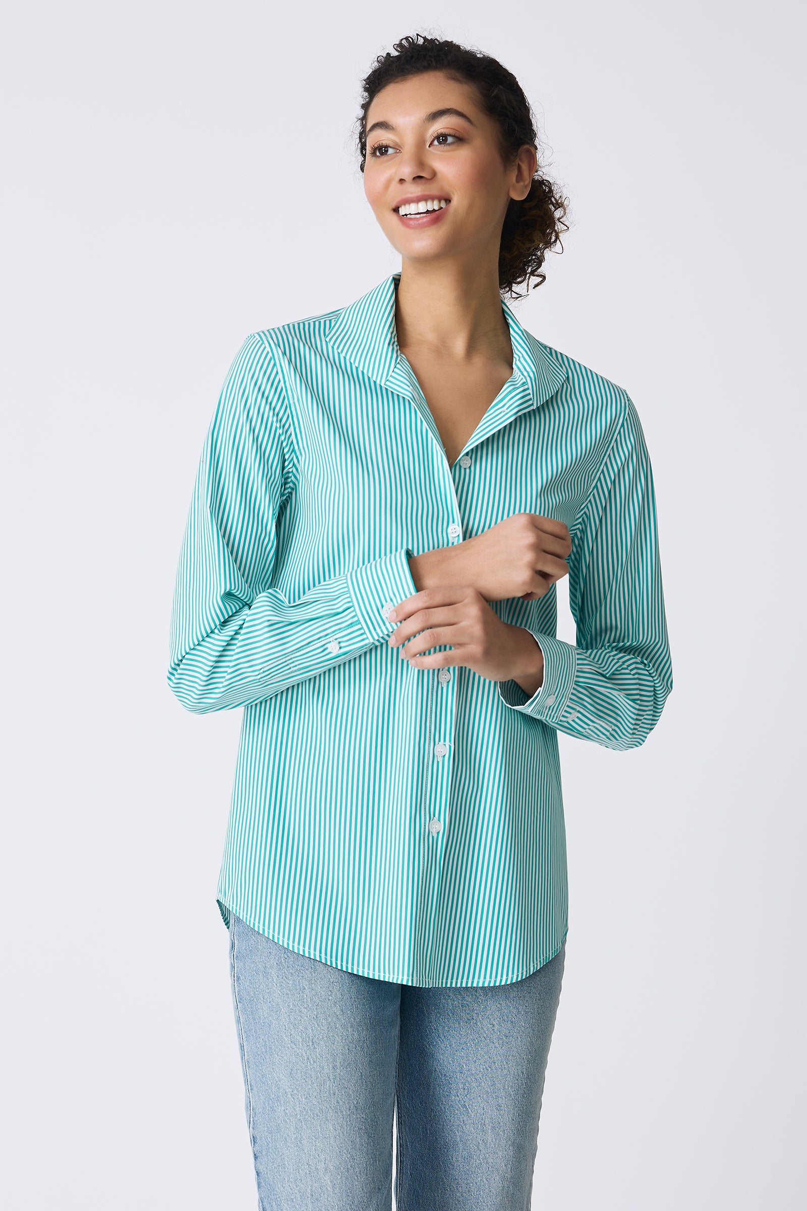 Kal Rieman image of the Ginna Box Pleat Shirt in Miami Stripe Green on model touching wrist and smiling