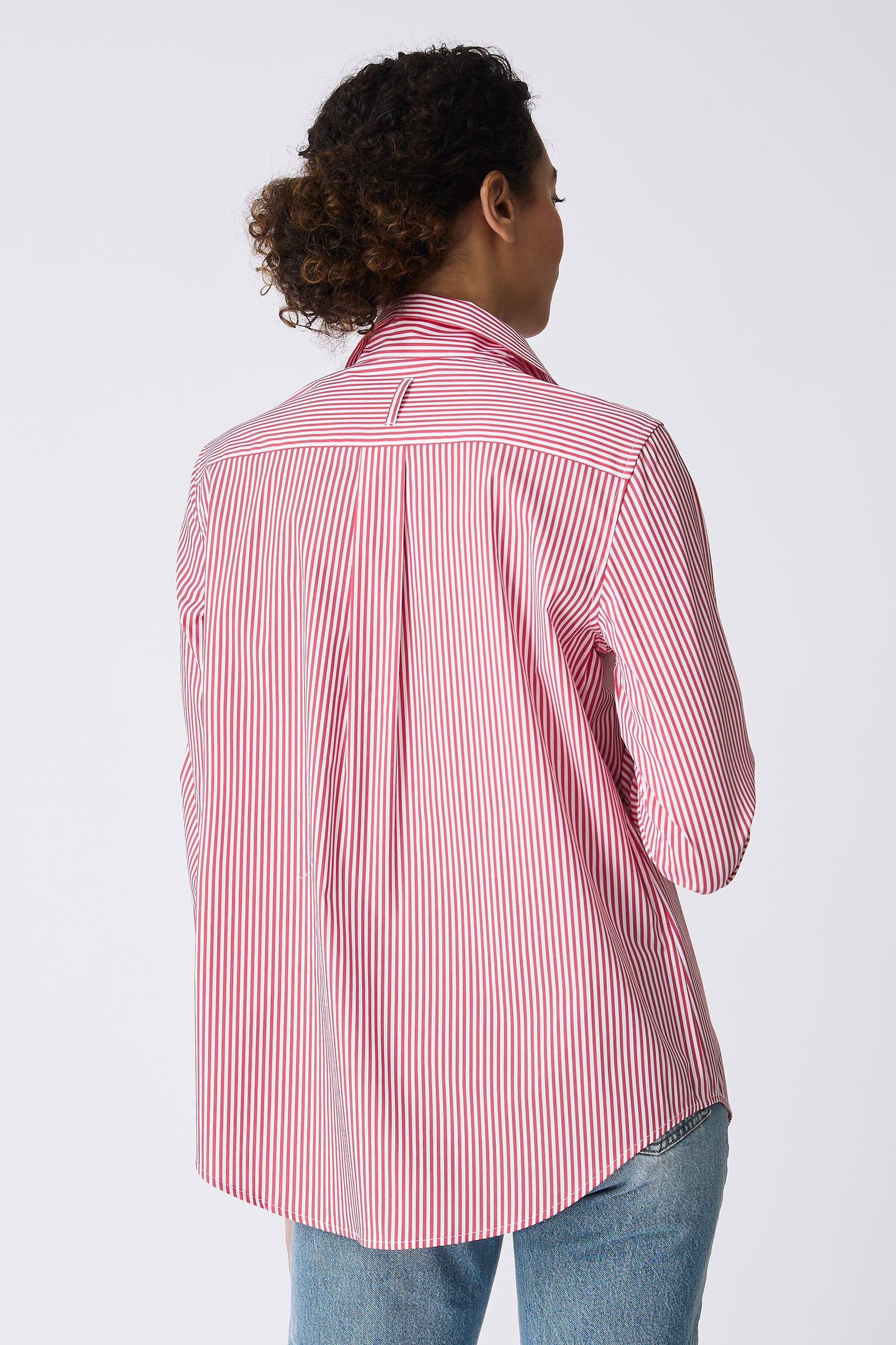 Kal Rieman image of the Ginna Box Pleat Shirt in Miami Stripe Red on model touching buttons front view