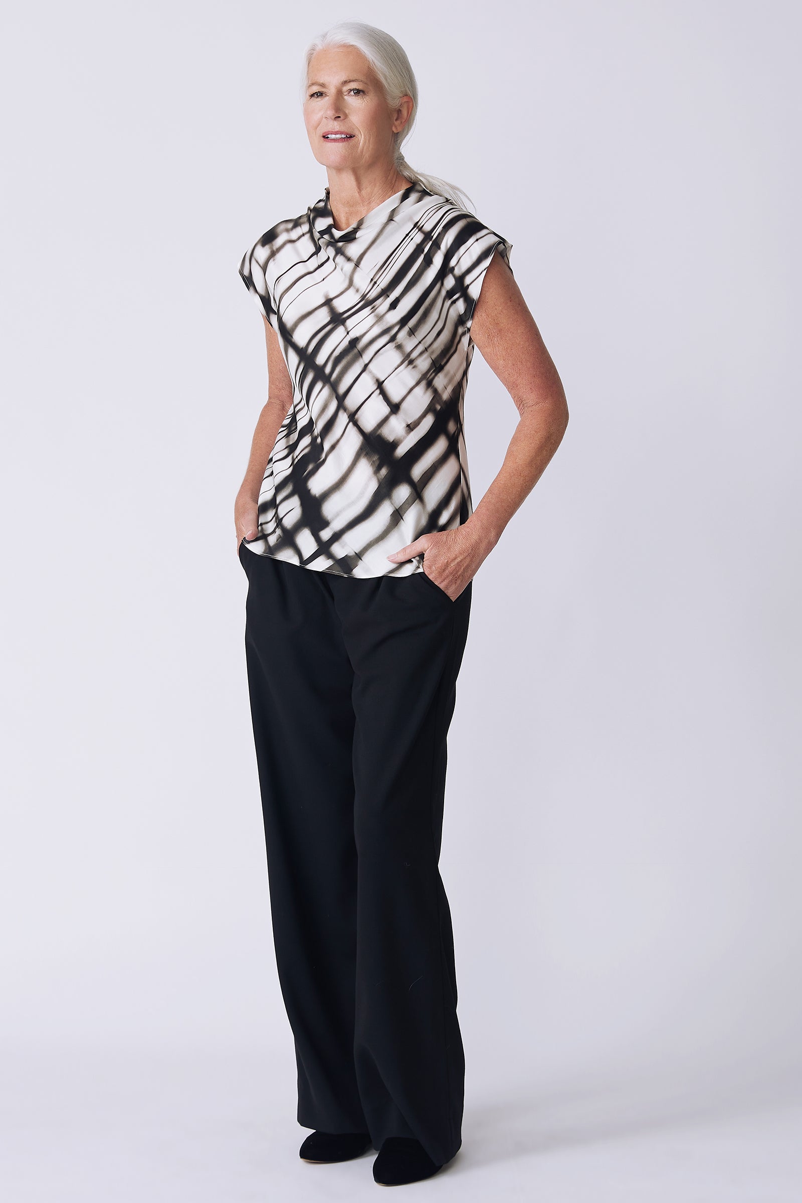 Kal Rieman Gloria Top in water color on model side view hands in pockets knee bent
