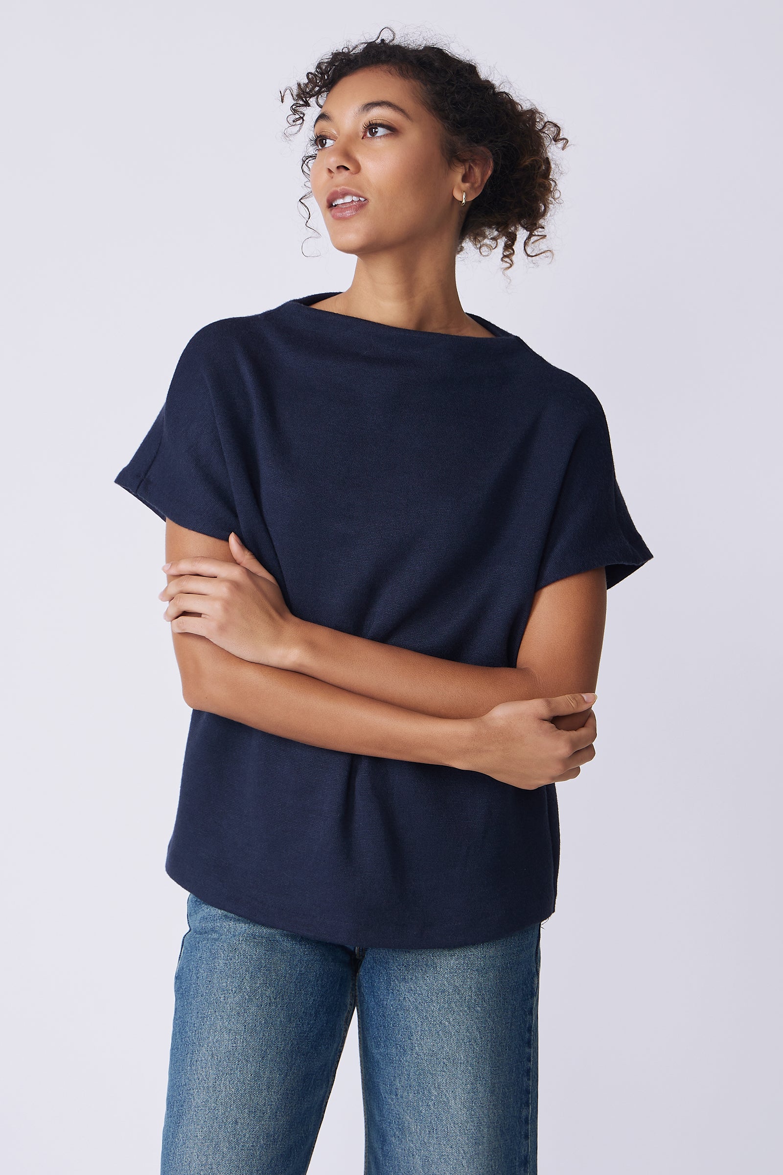 Kal Rieman Hanna Top in navy brushed knit on model front view arms folded looking up