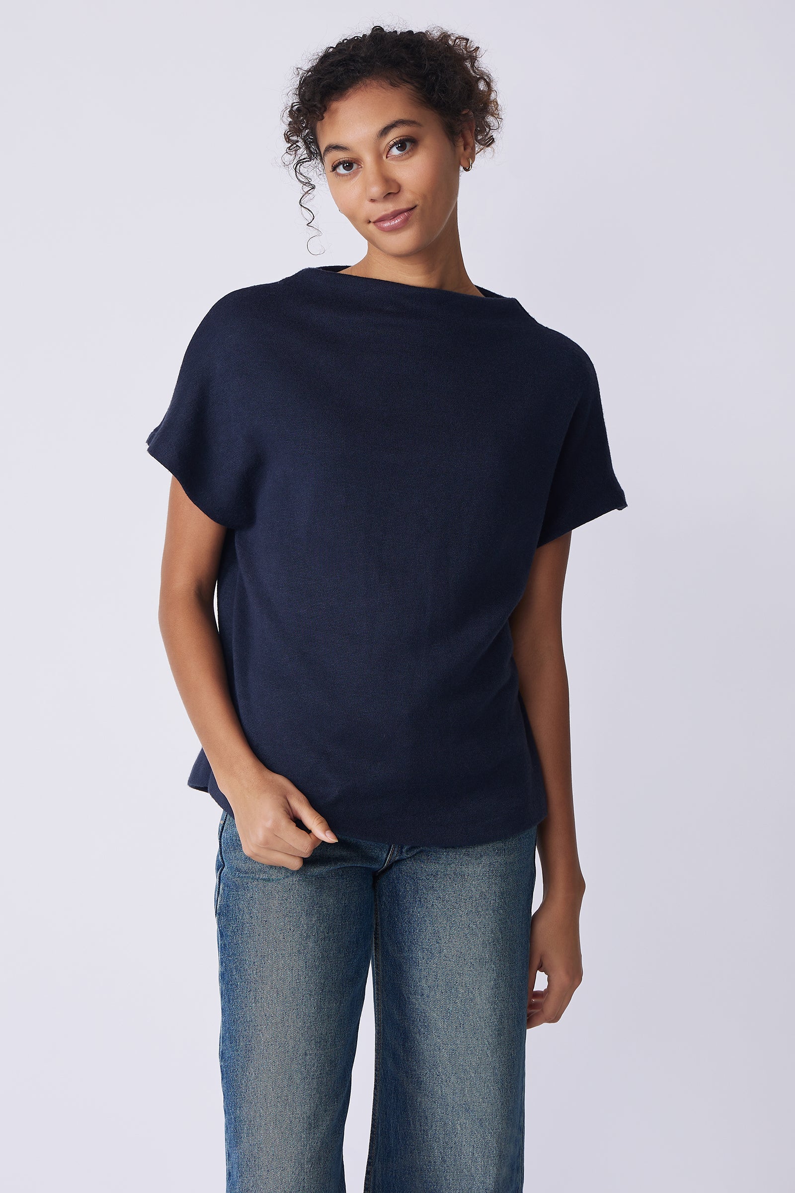 Kal Rieman Hanna Top in navy brushed knit on model front view holding hem