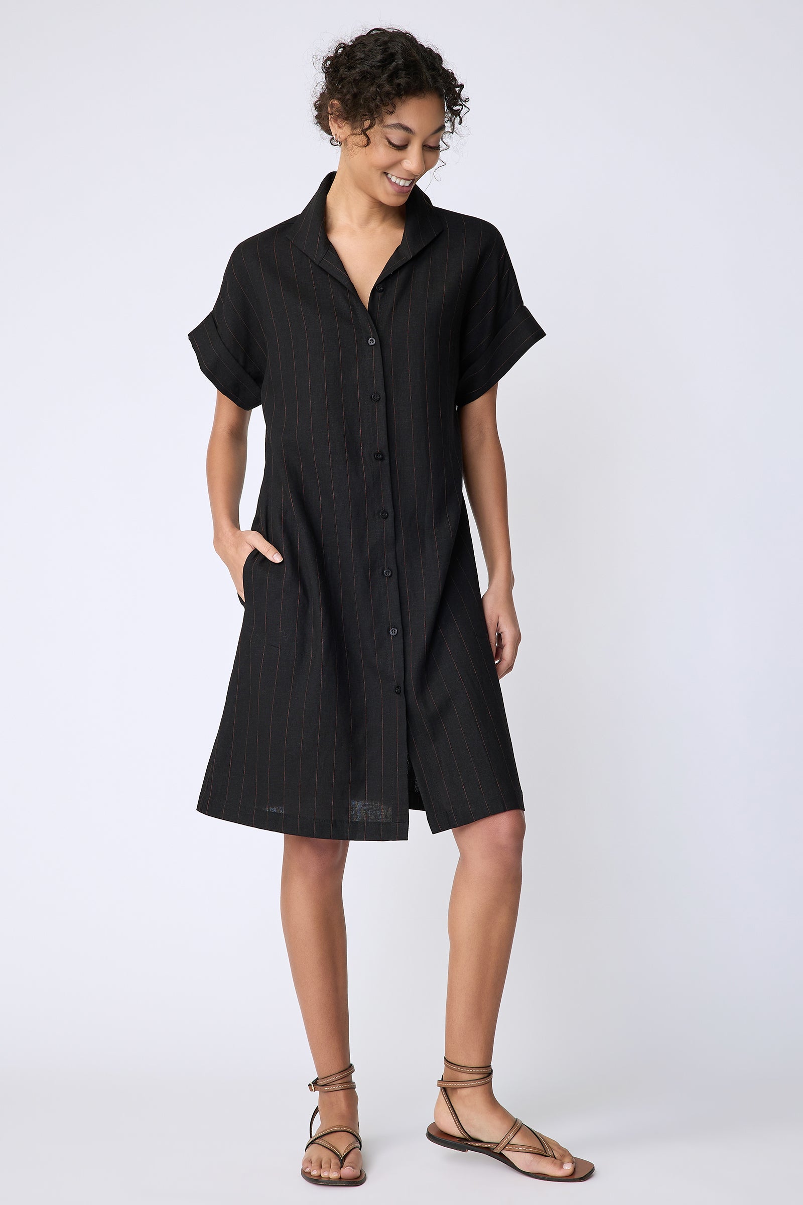 Kal Rieman Holly Kimono Dress in black pinstripe linen on model front view hand in pocket