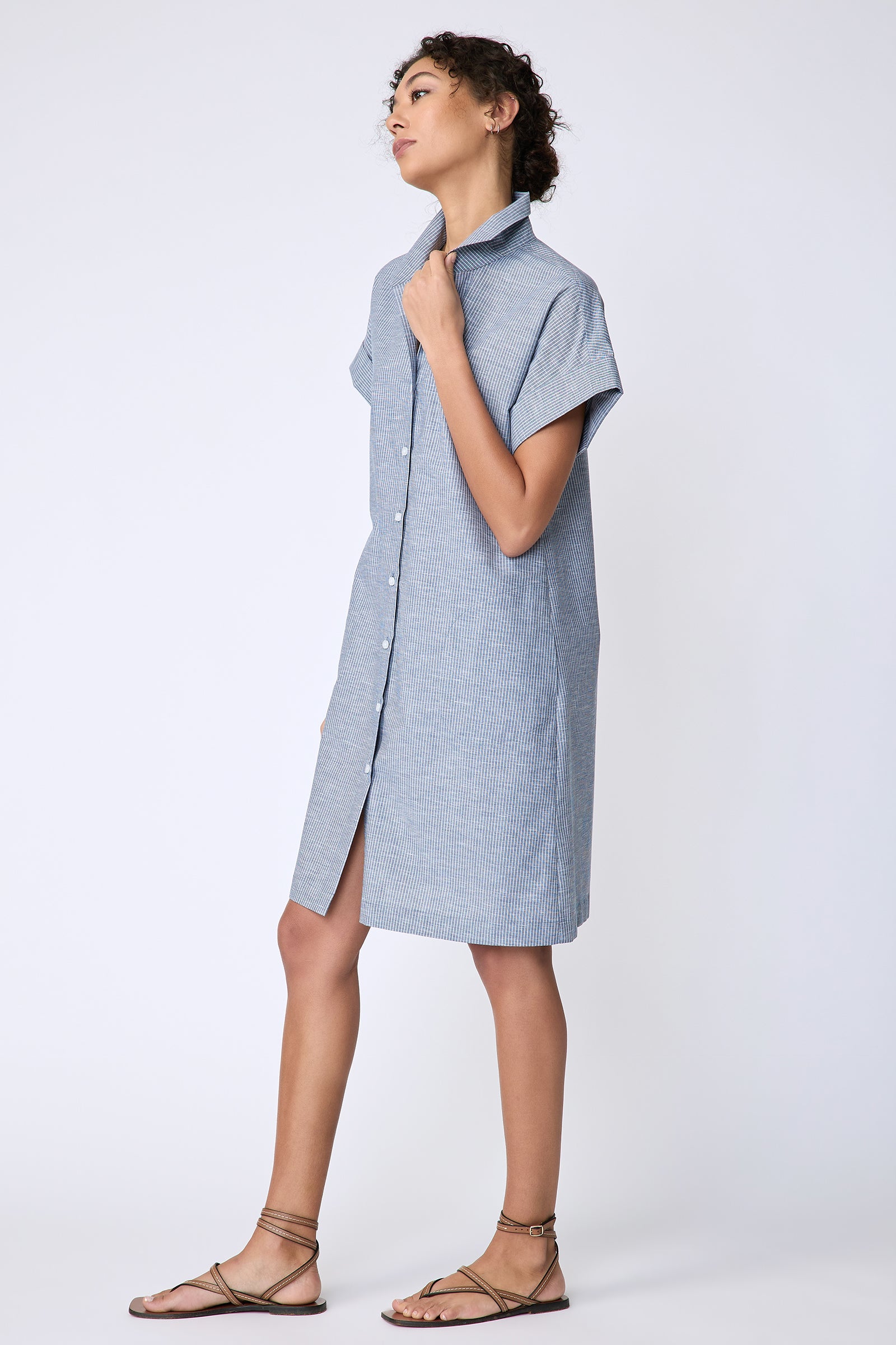 Kal Rieman Holly Kimono Dress in dark indigo mini stripe on model side view holding placket
