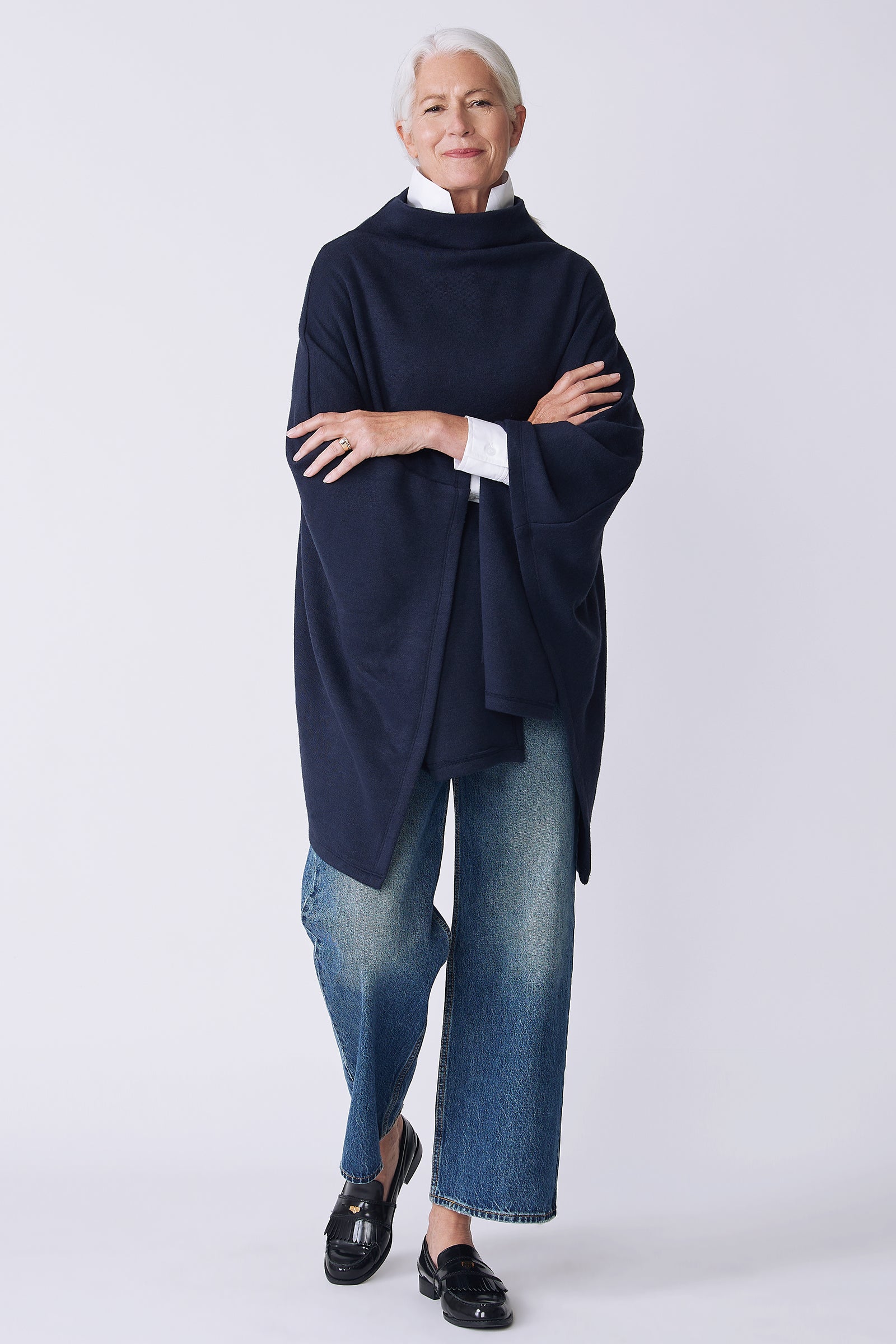 Kal Rieman Jackie Cape in blue knit on model front view arms crossed walking