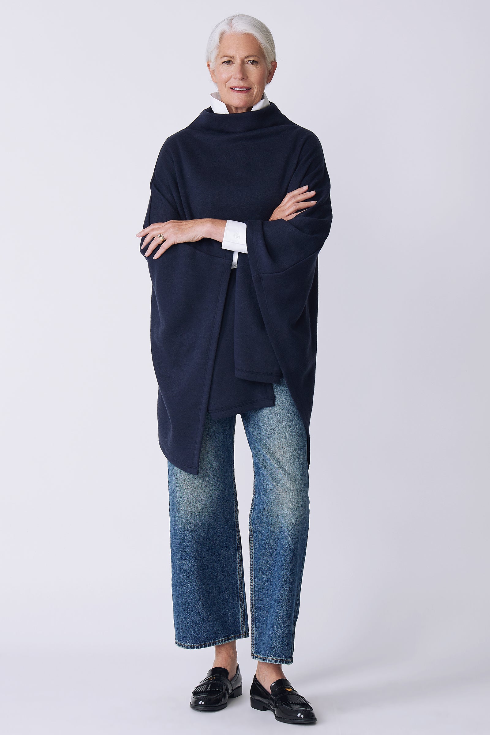 Kal Rieman Jackie Cape in blue knit on model front view arms crossed
