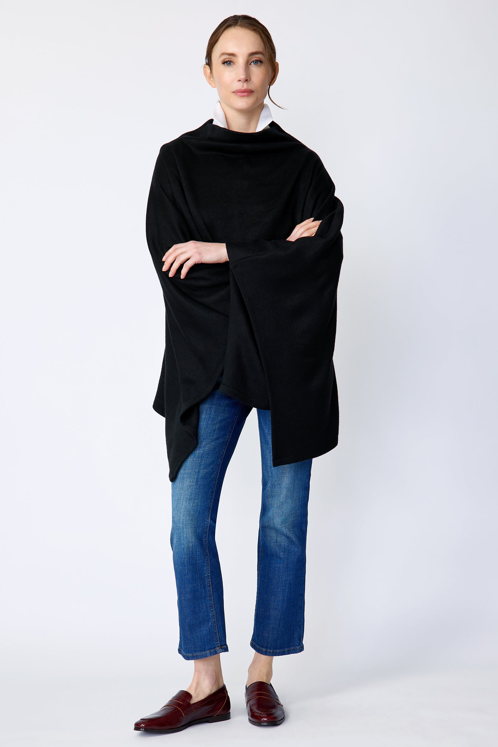 Kal Rieman Jackie Poncho in black soft knit on model front view full arms crossed in front