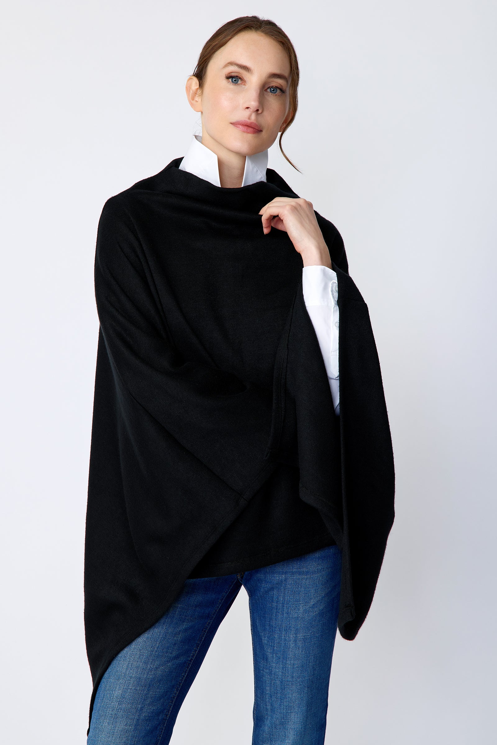 Kal Rieman Jackie Poncho in black soft knit on model front view holding collar