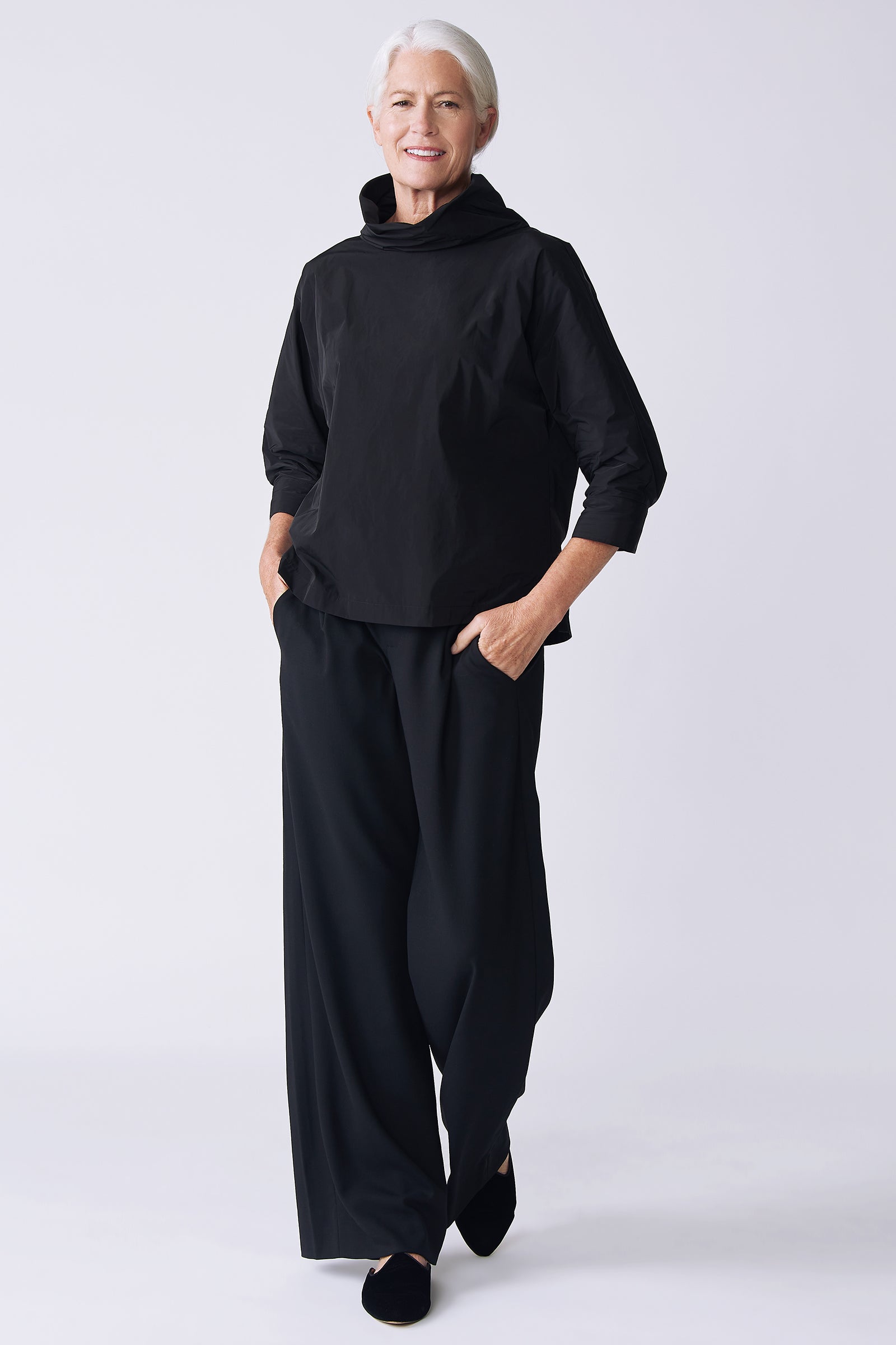 Kal Rieman Julia Taffeta Top in black on model front view walking