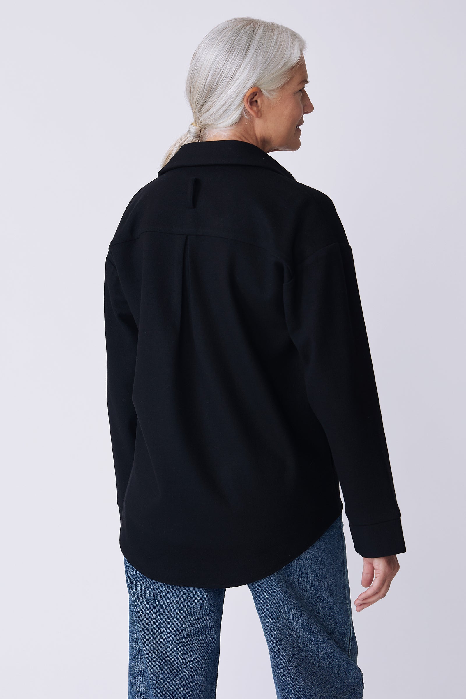 Kal Rieman Julian pullover in black felted jersey on model front view walking