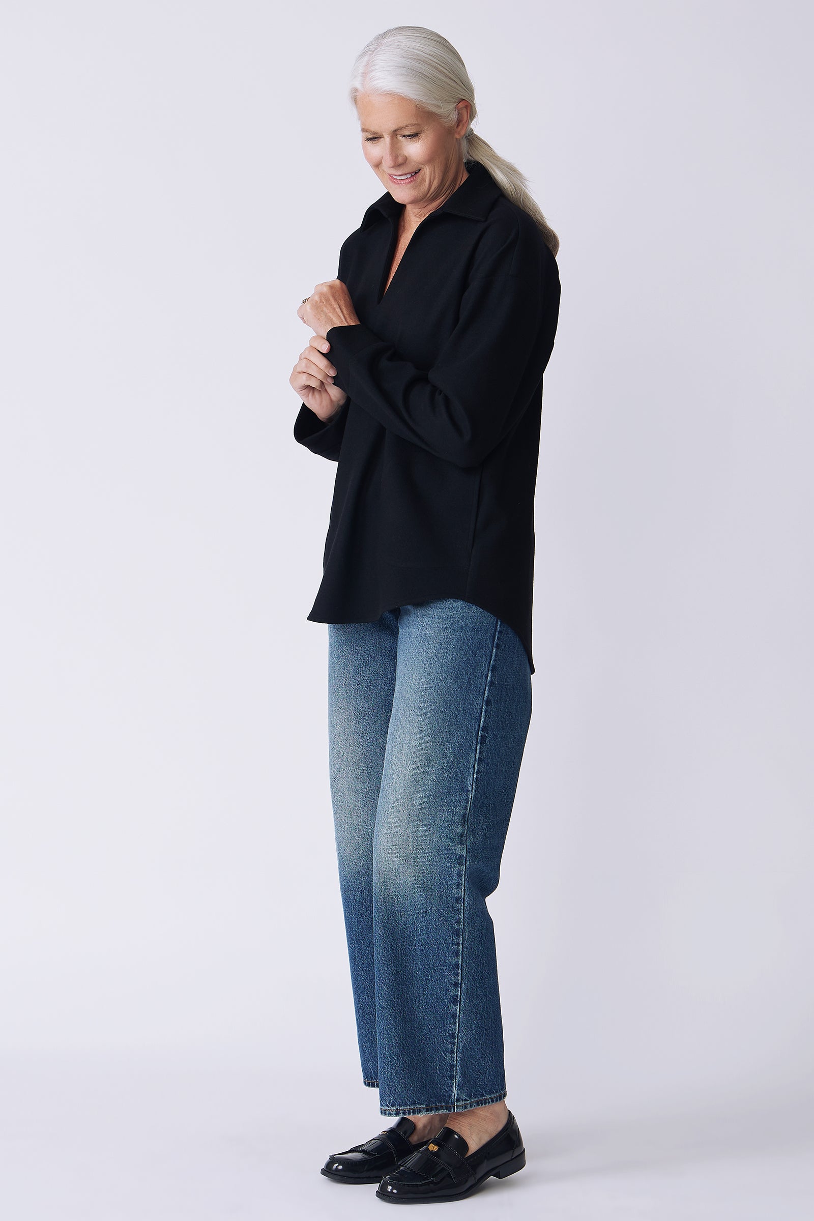 Kal Rieman Julian pullover in black felted jersey on model side view holding cuff