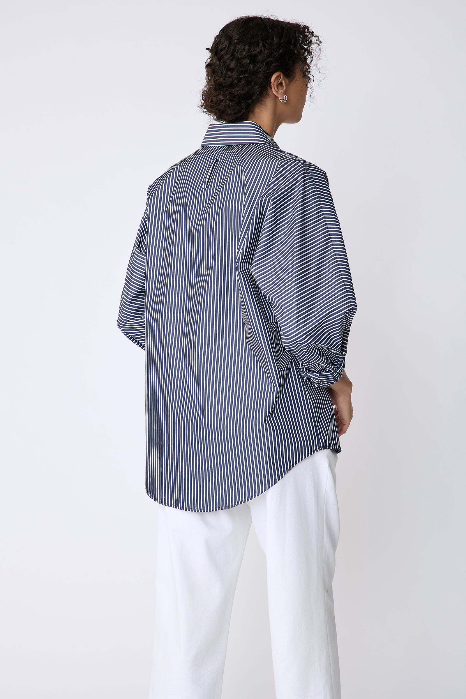 Kal Rieman Lauren Blouse in savoy stripe on model front view arms crossed