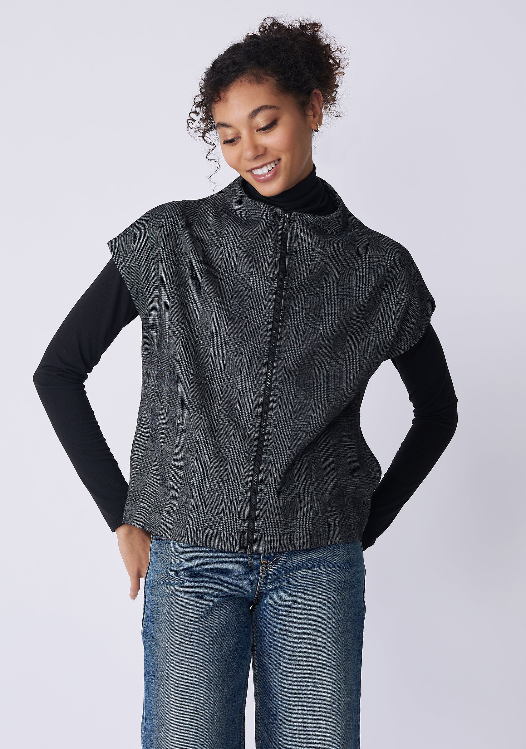 Kal Rieman Lena Zip Vest in black plaid on model front view hands on hips