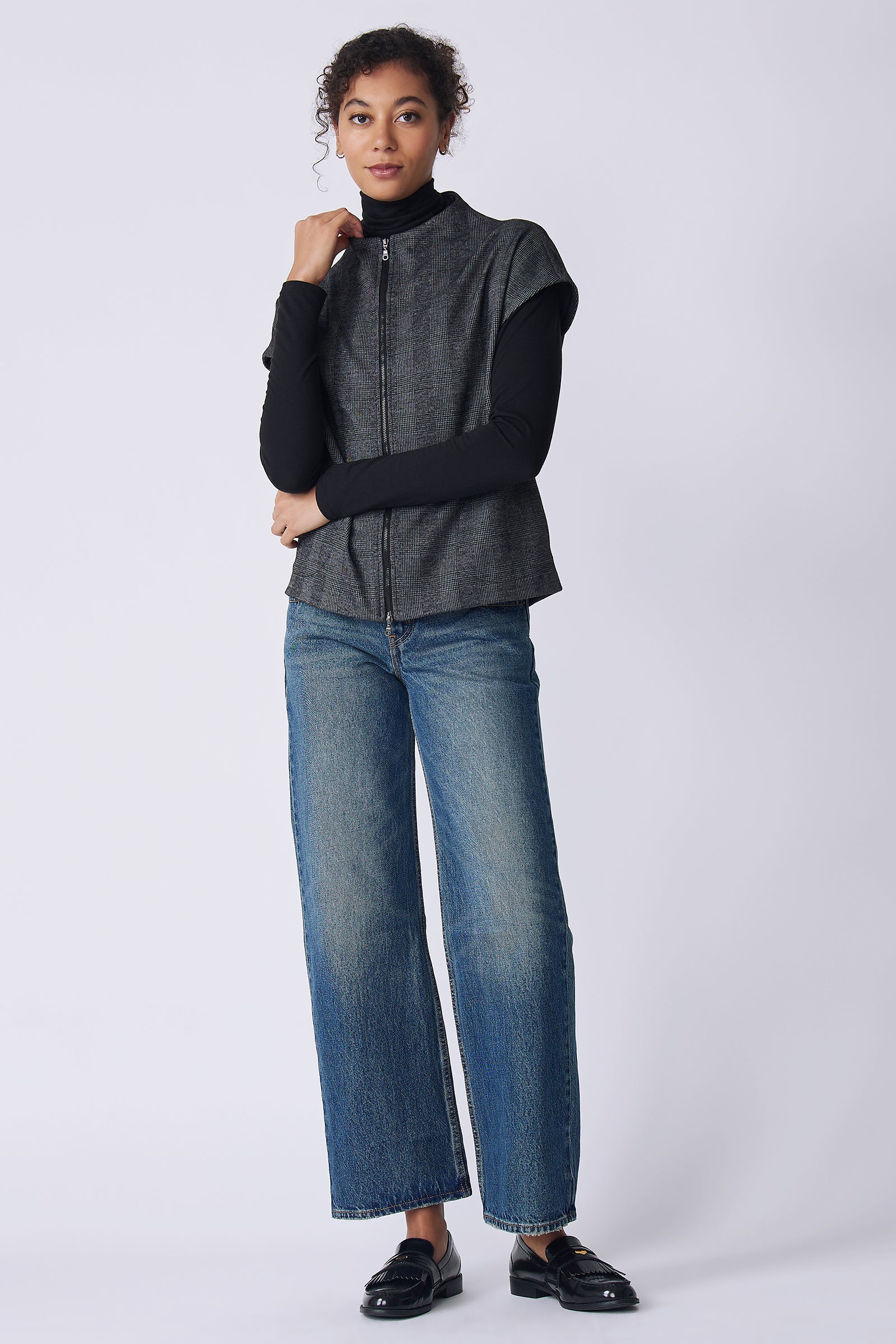 Kal Rieman Lena Zip Vest in black plaid on model front view holding collar
