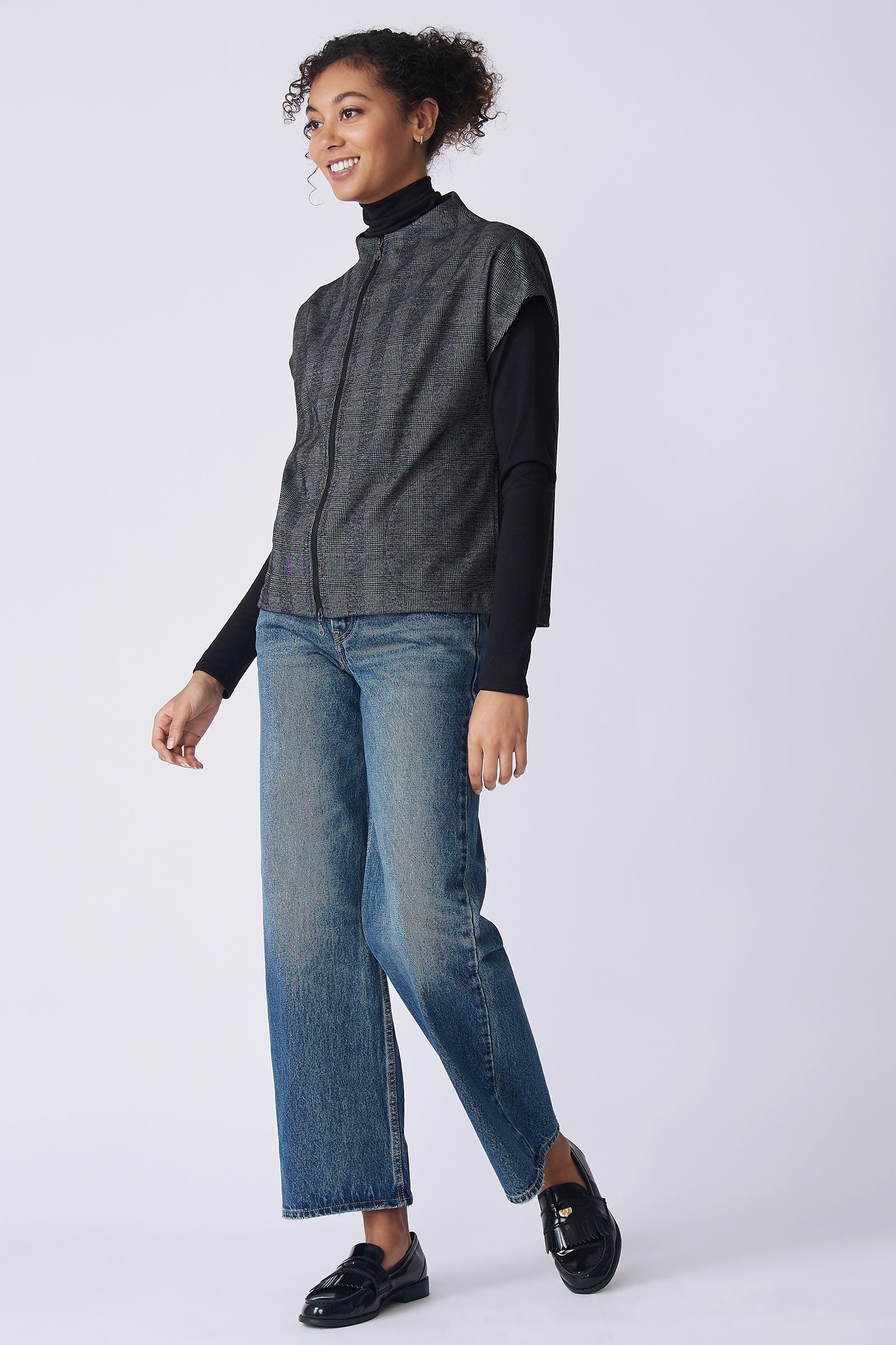 Kal Rieman Lena Zip Vest in black plaid on model side view walking