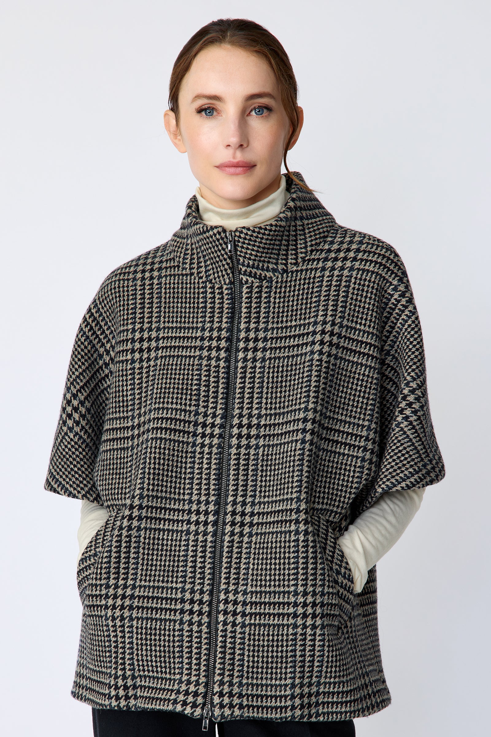 Woman wearing the Kal Rieman London Zip Vest in Multi Plaid and black pants, hands in pockets, close view