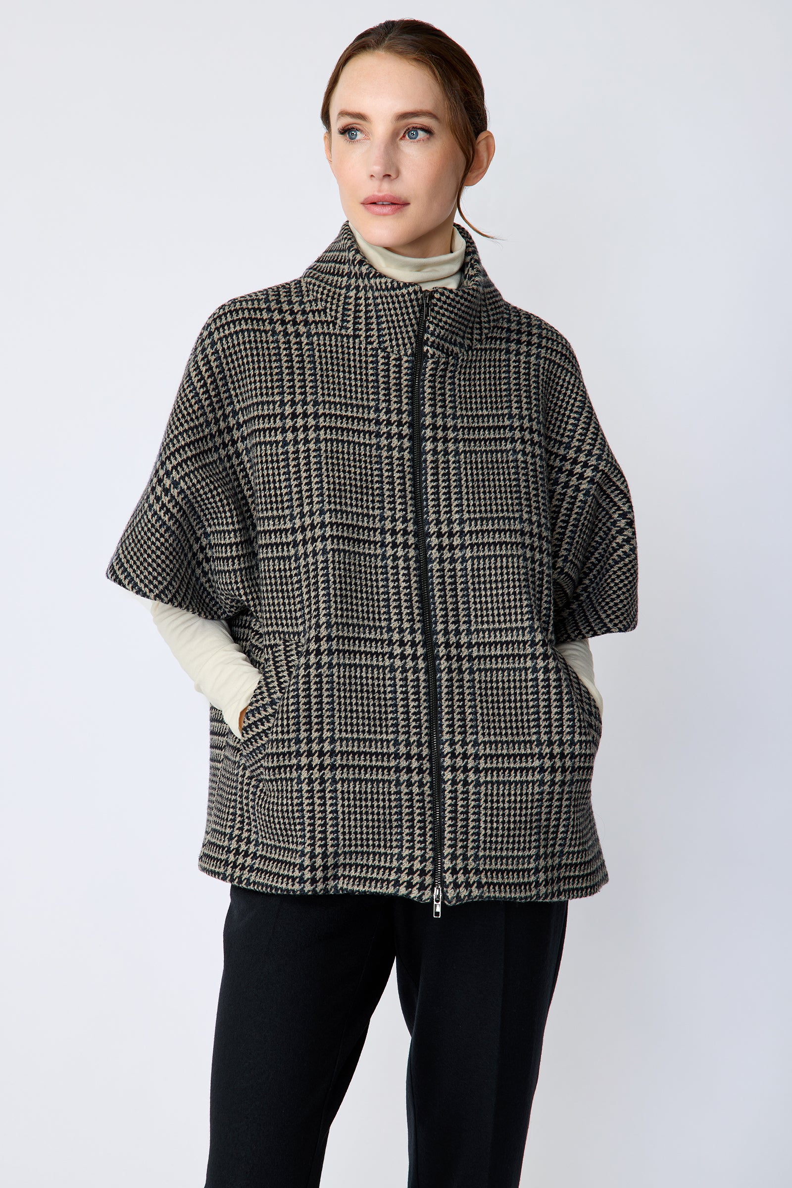 Woman wearing the Kal Rieman London Zip Vest in Multi Plaid and black pants, hands in pockets, close view, looking sideways