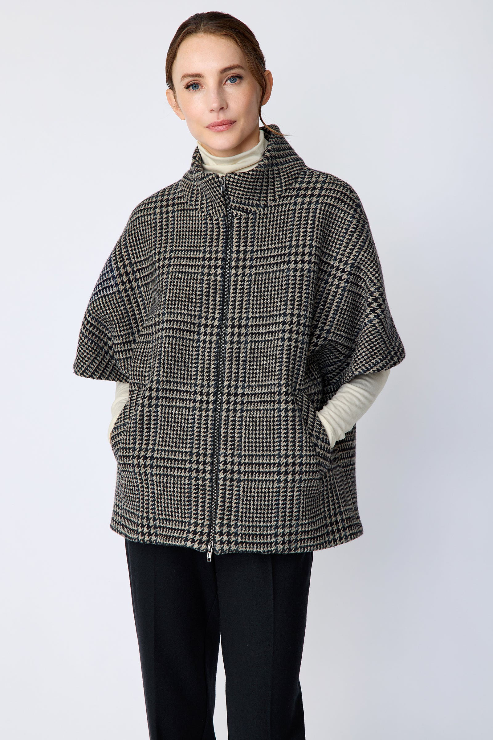 Woman wearing the Kal Rieman London Zip Vest in Multi Plaid and black pants, hands in pockets, close view