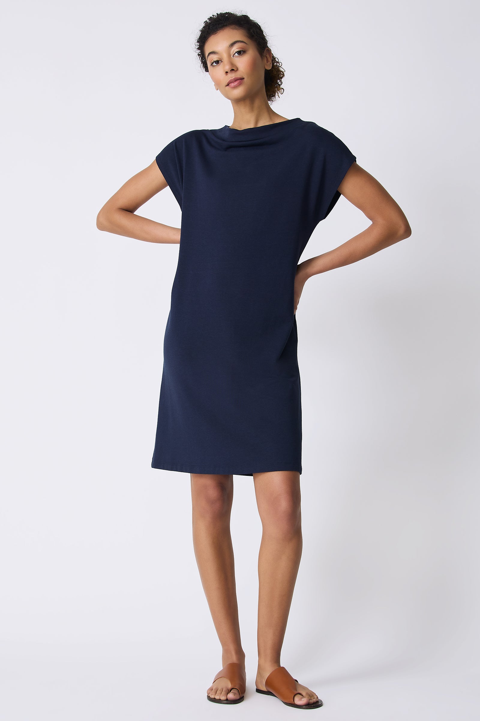 Kal Rieman Luca Cowl Dress in Navy on model with hands on hips full front view