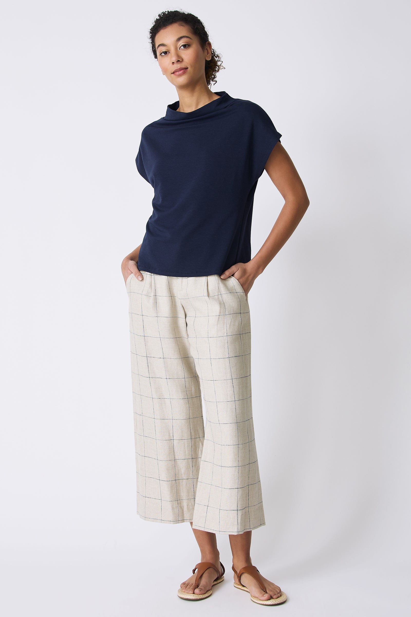 Kal Rieman Luca Cowl Top in Navy on model with hands in pockets full front view