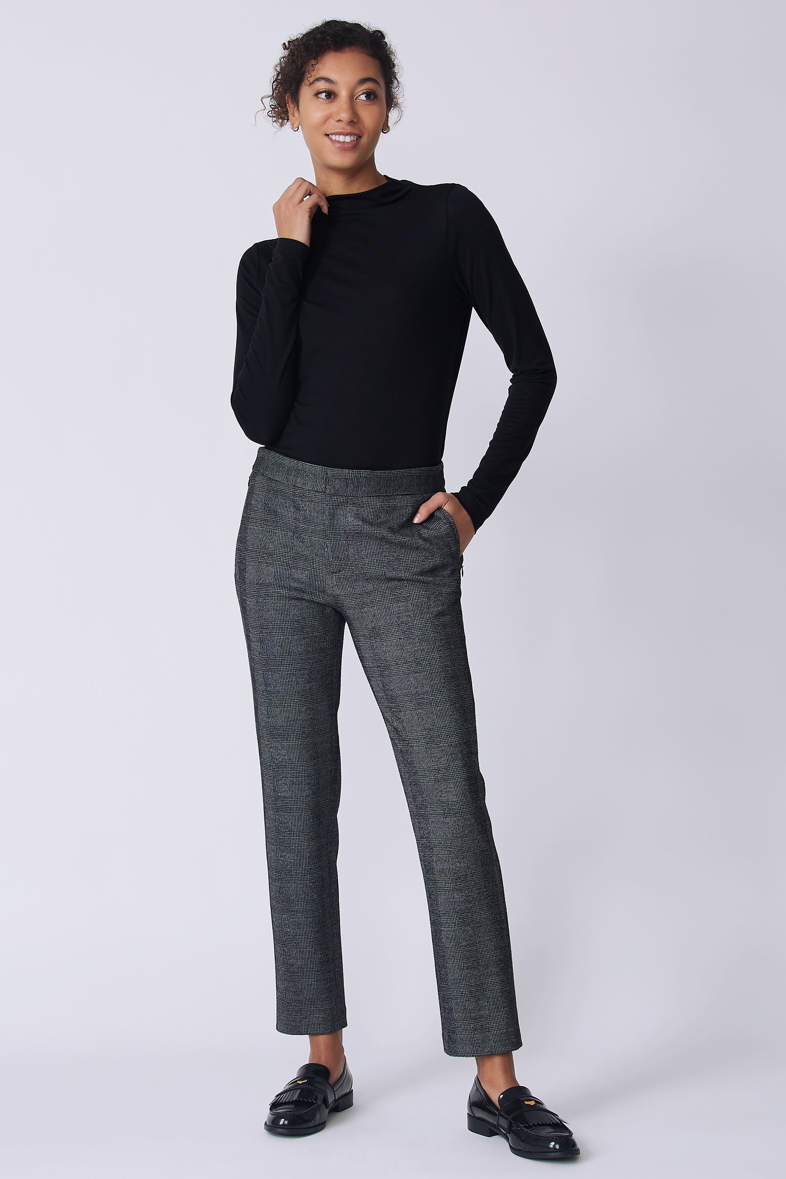 Kal Rieman Madison Pant in black plaid on model front view hand in pocket holding collar