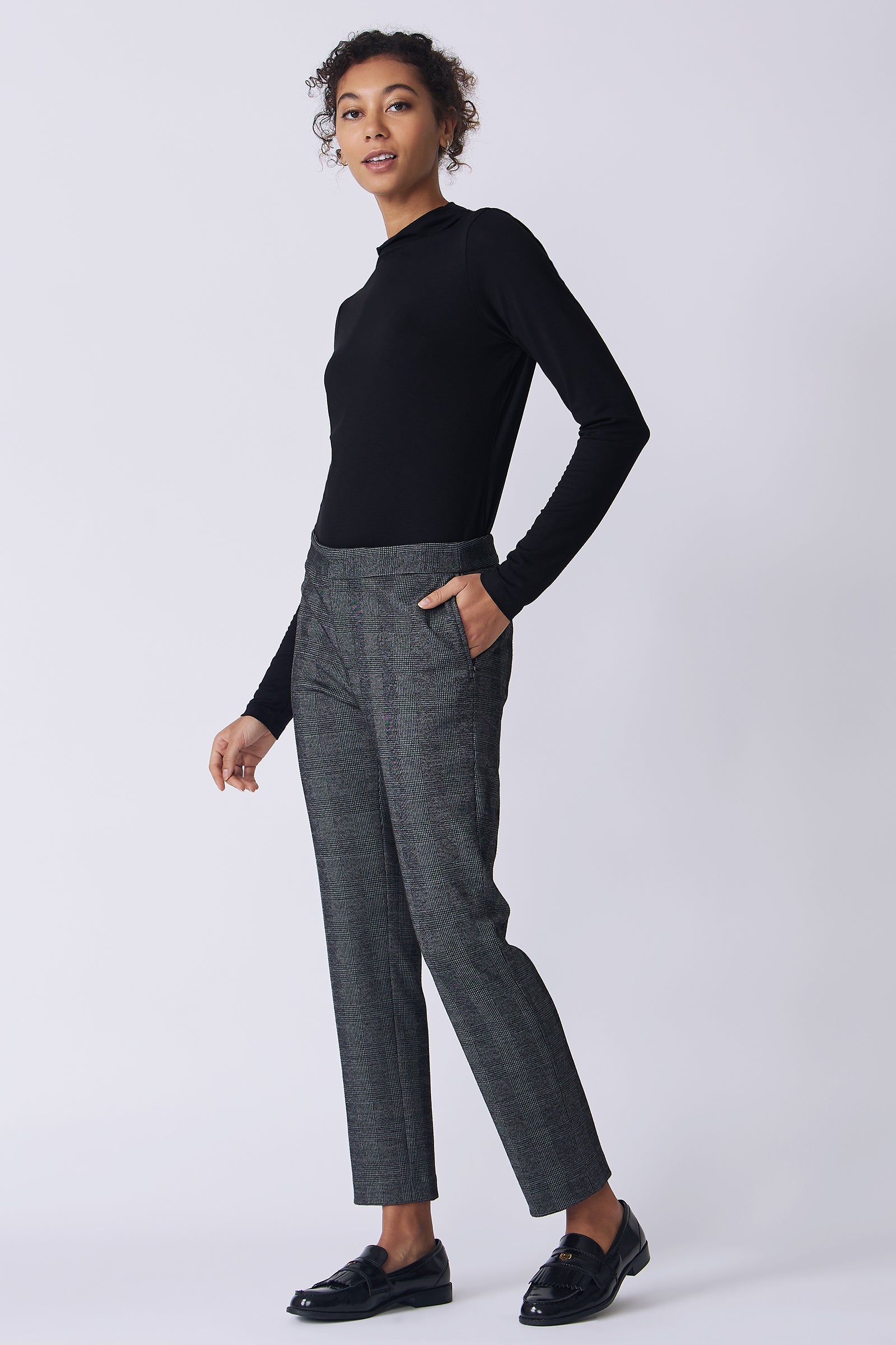 Kal Rieman Madison Pant in black plaid on model side view walking