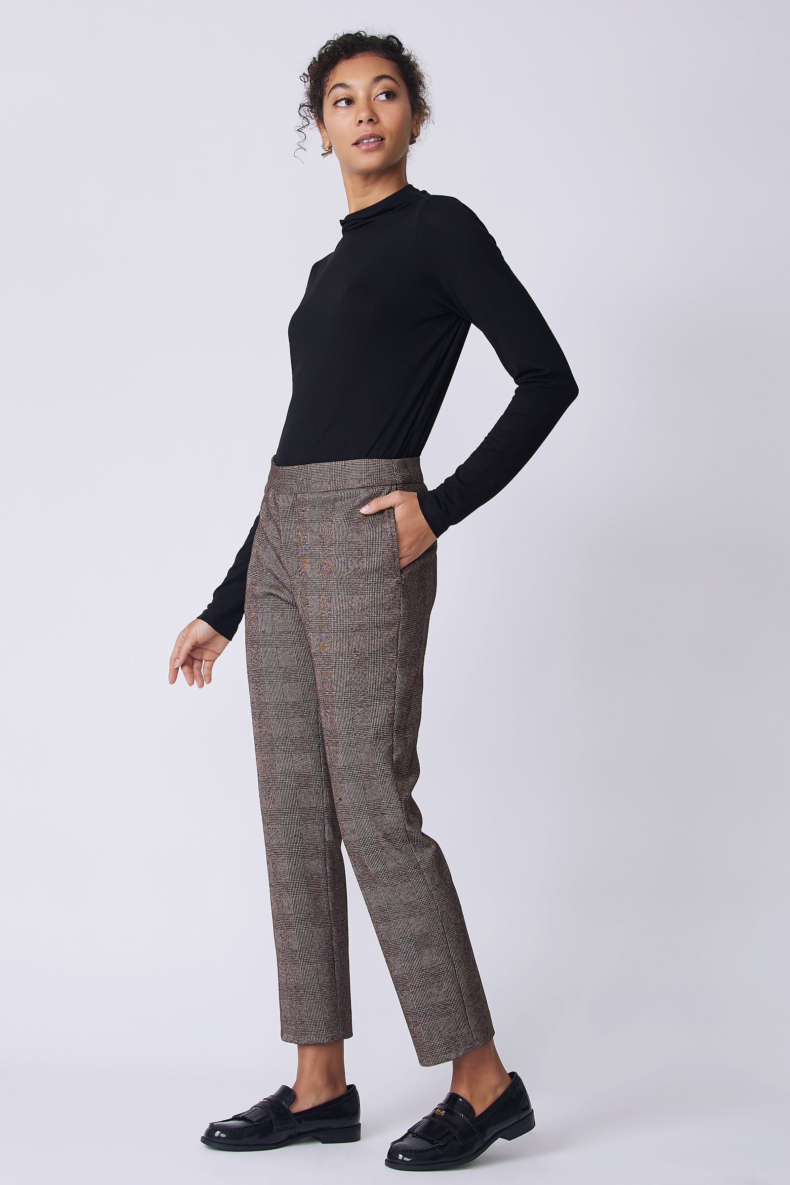Kal Rieman Madison Pant in brown plaid on model side view walking
