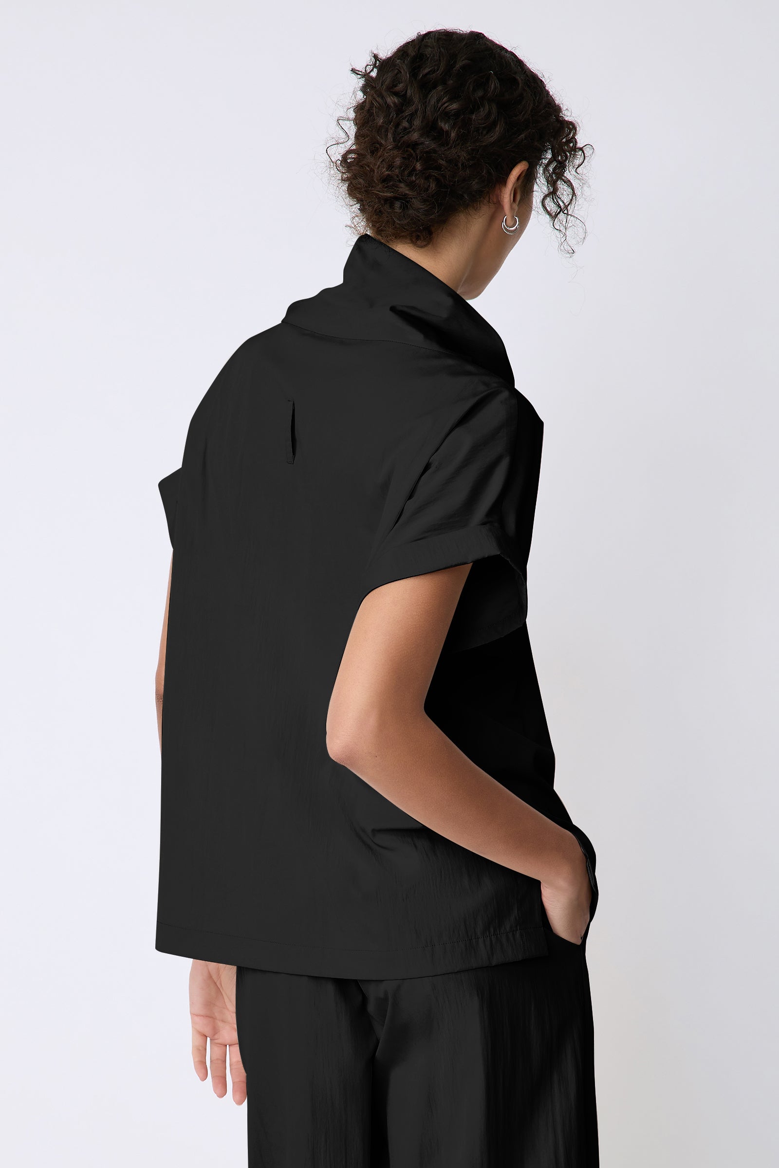 Kal Rieman Maggie Top in Typewriter Cloth black on model back view hand in pocket