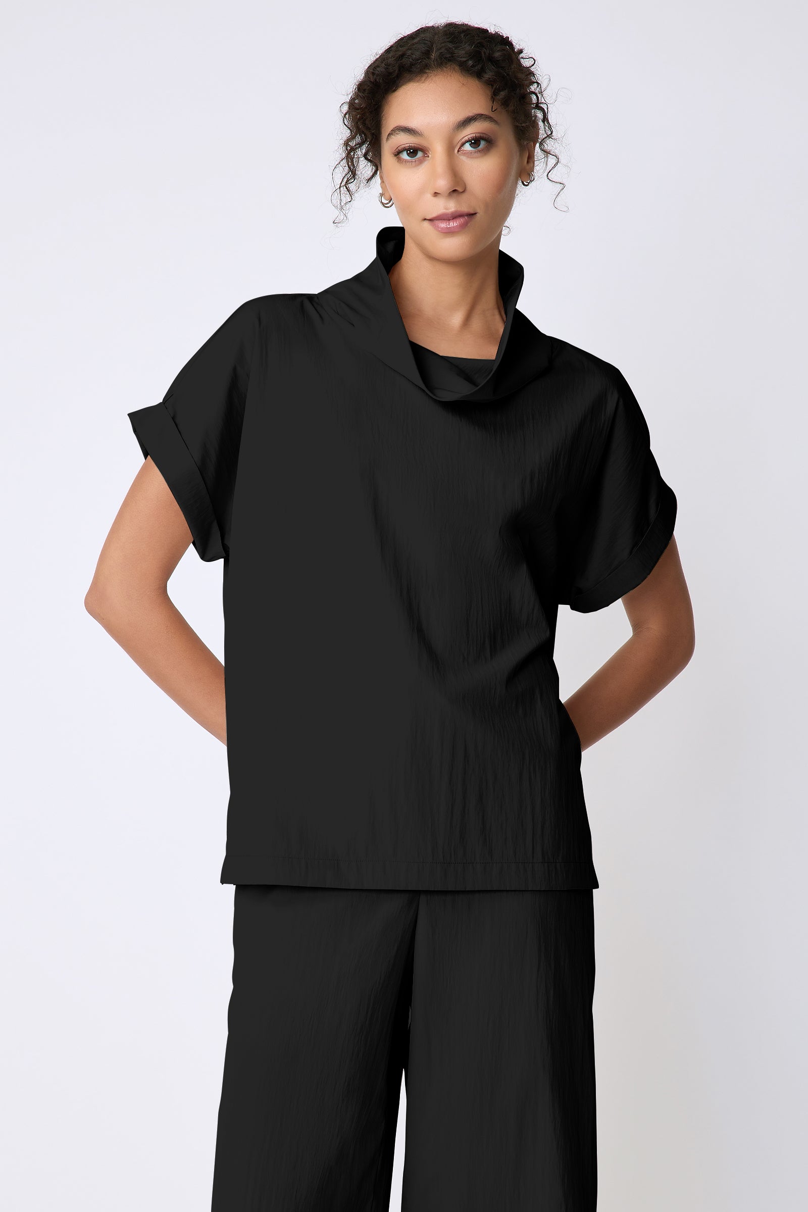Kal Rieman Maggie Top in Typewriter Cloth black on model front view hands behind back