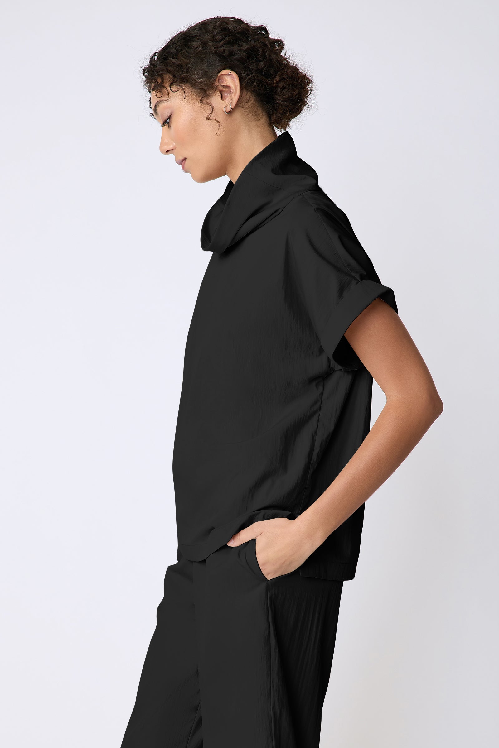 Kal Rieman Maggie Top in Typewriter Cloth black on model side view hand in pocket
