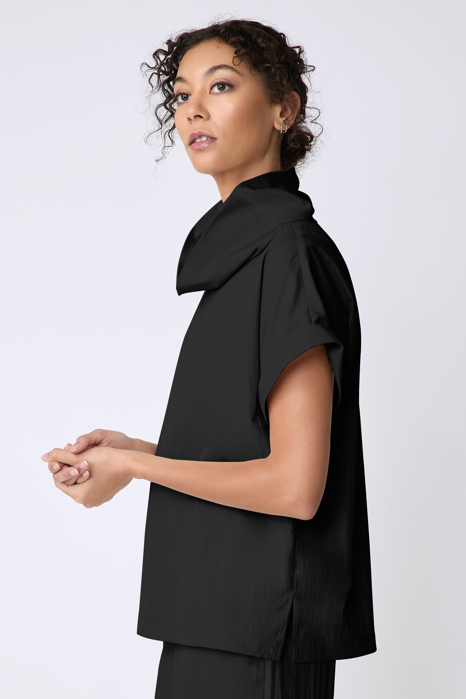Kal Rieman Maggie Top in Typewriter Cloth black on model side view hands in front