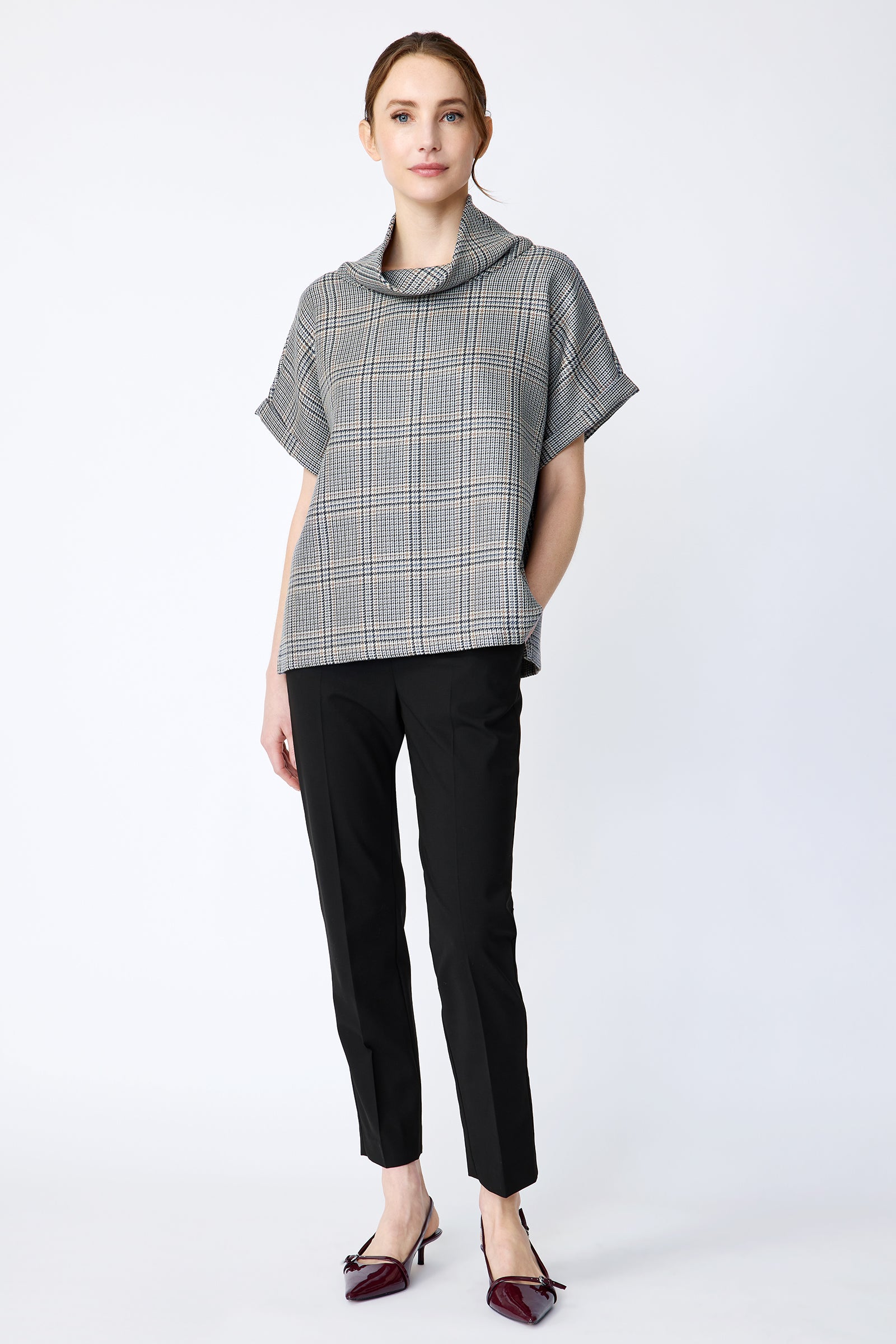 Woman wearing Kal Rieman Marin Top in Glen Plaid and black pants on a white background, hand in pant pocket