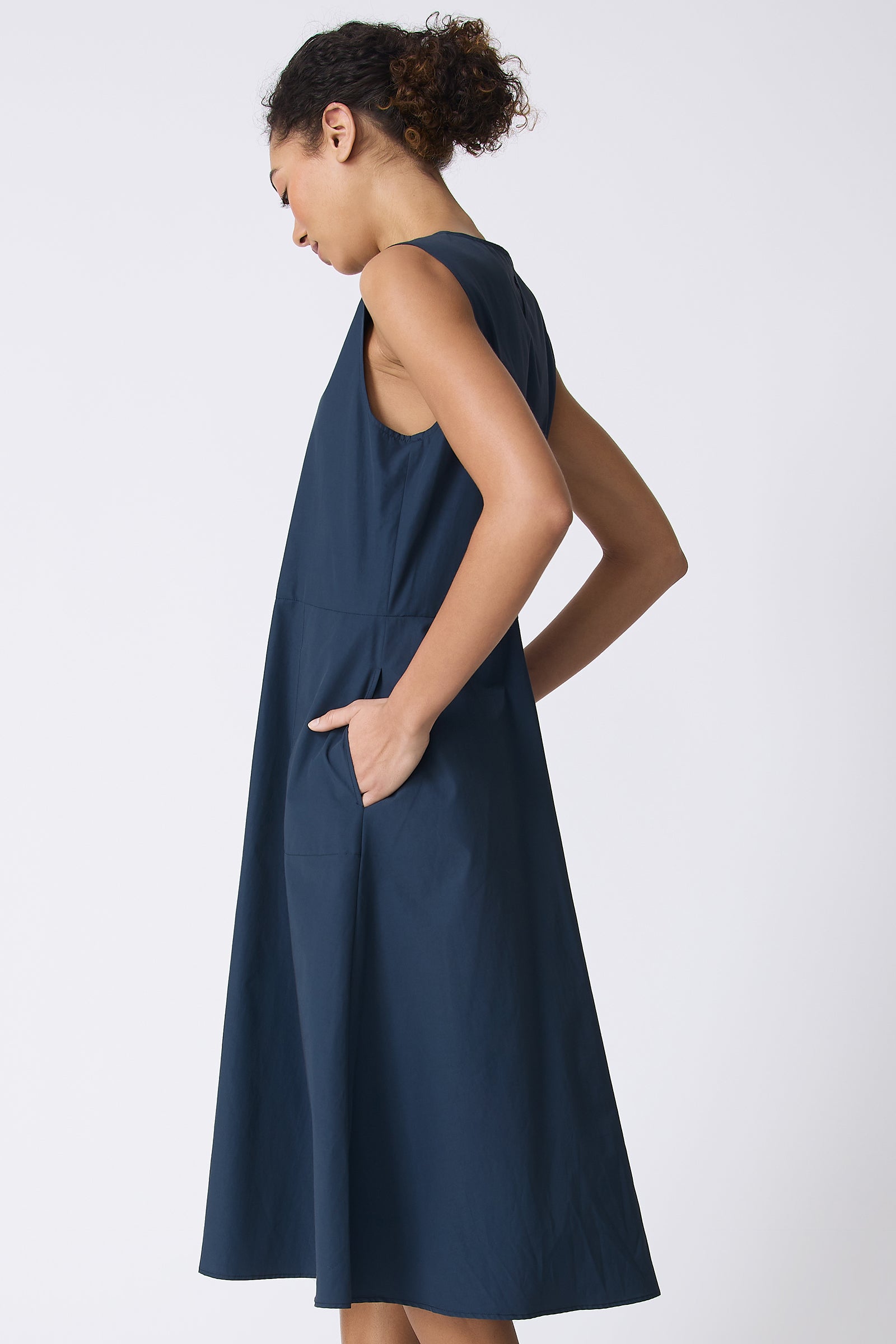 Kal Rieman Marina Dress in Summer Navy on model with hands in pockets side view
