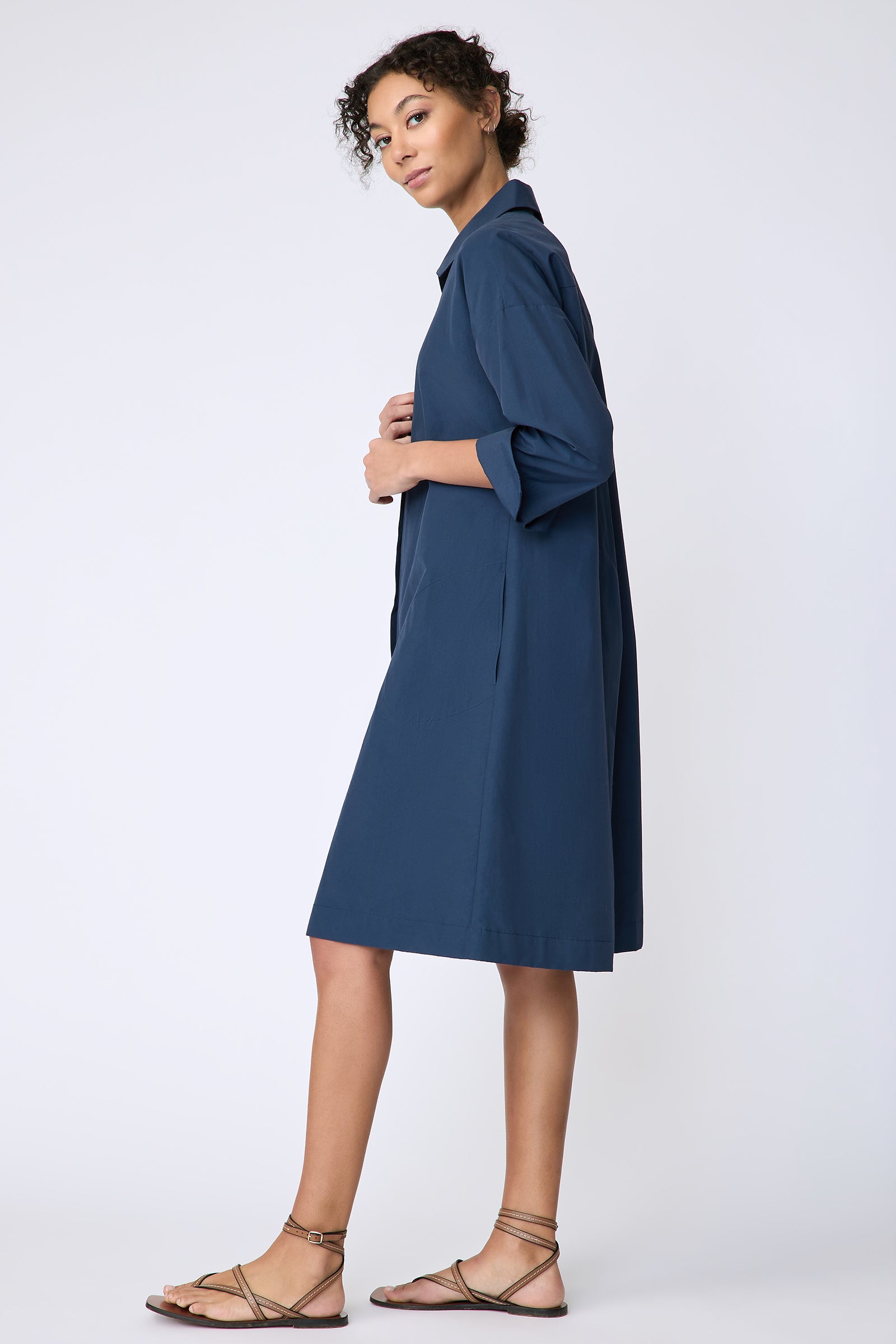 Kal Rieman Marion Shirt Dress in Italian broadcloth summer navy on model side view hands in front
