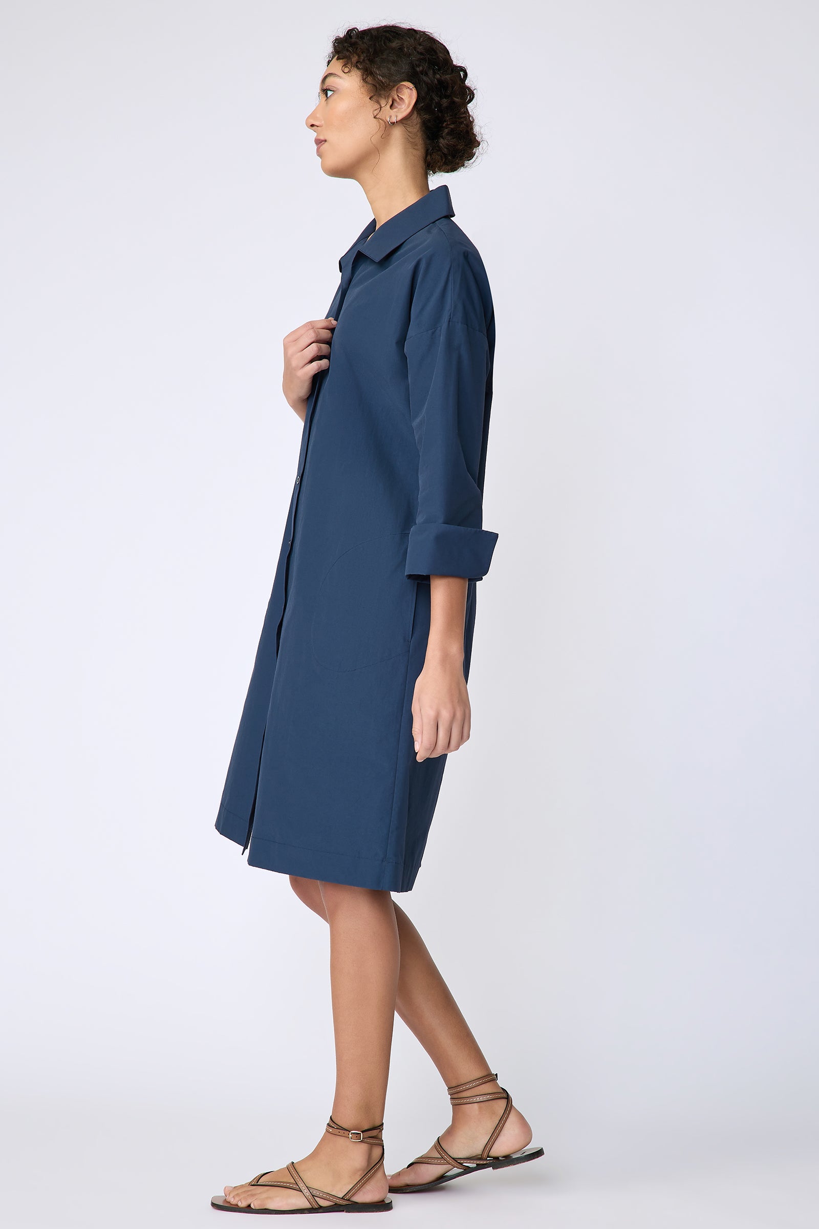 Kal Rieman Marion Shirt Dress in Italian broadcloth summer navy on model side view holding placket