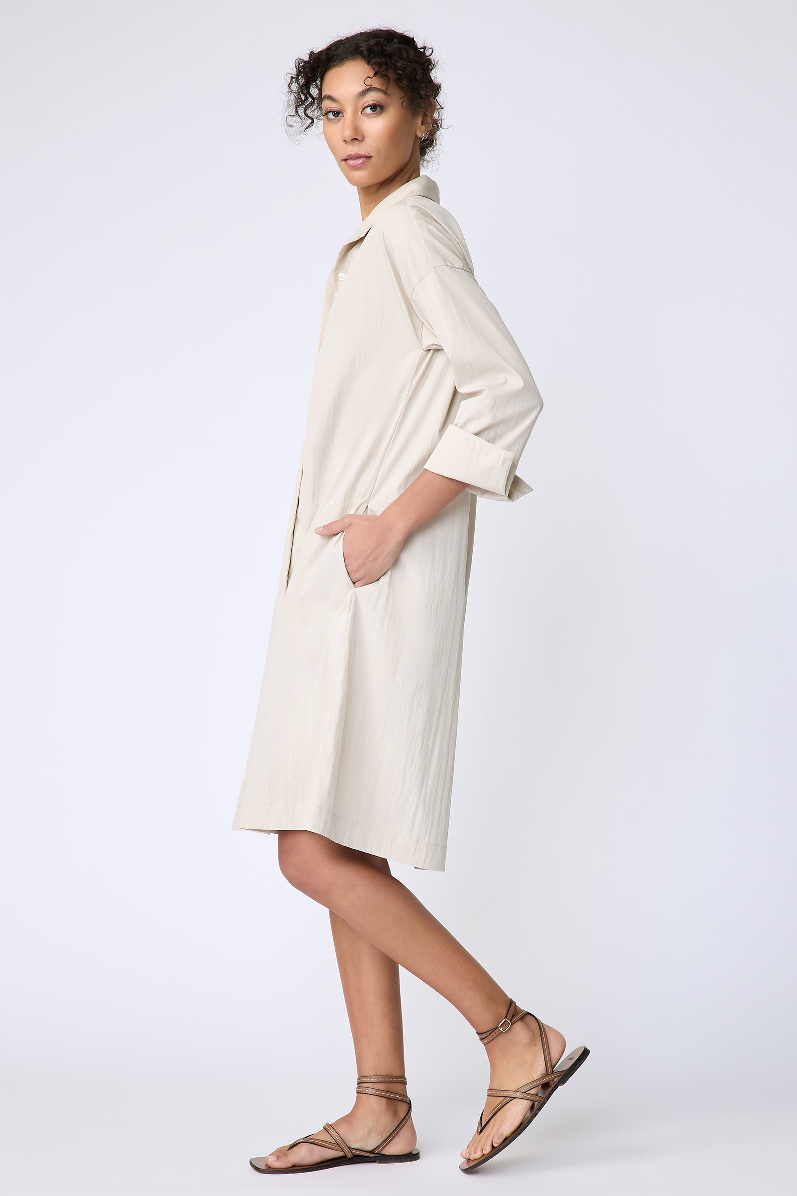 Kal Rieman Marion Shirt Dress in Typewriter cloth khaki on model side view walking hands in pockets