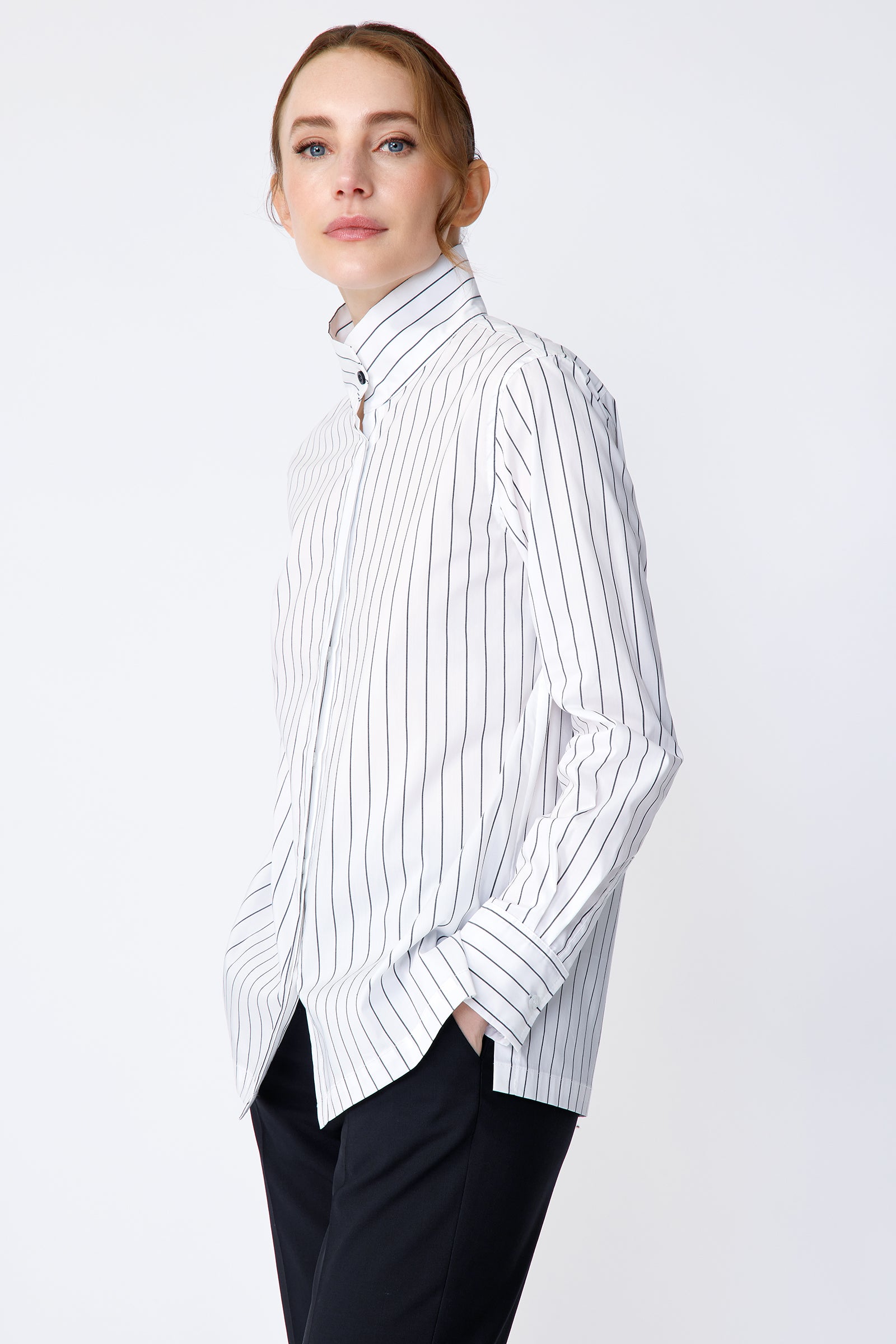 Kal Rieman Marlene Shirt in Piano Stripe stretch shirting on model side view hands in pockets looking at camera